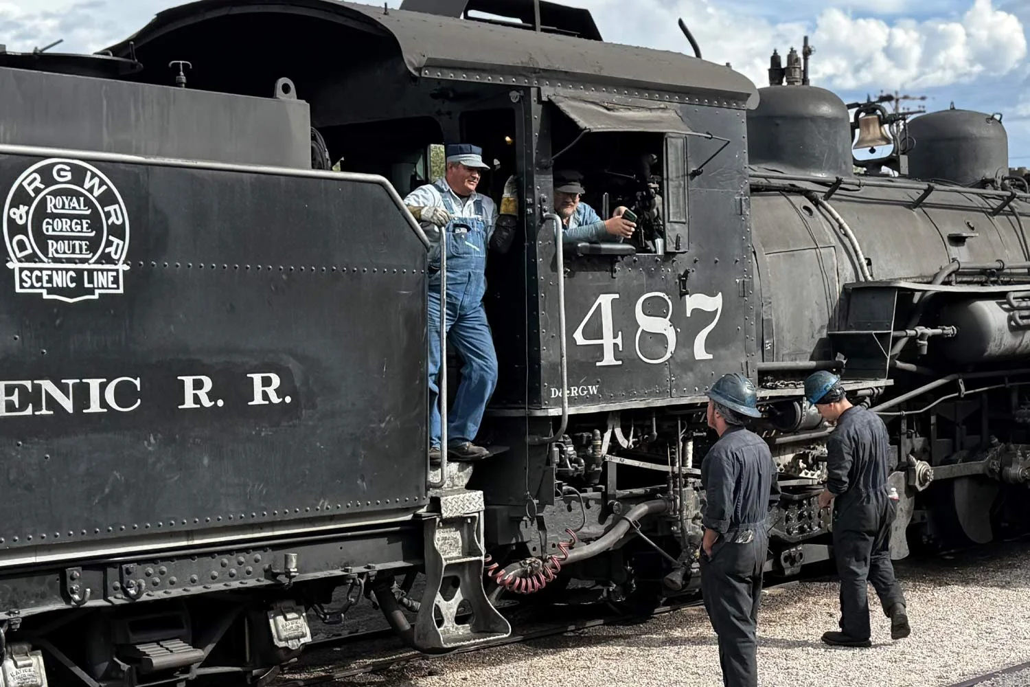Railroad conductor and train employees at the end of Cumbres &amp; Toltec Scenic Railroad day trip in Chama, NM 