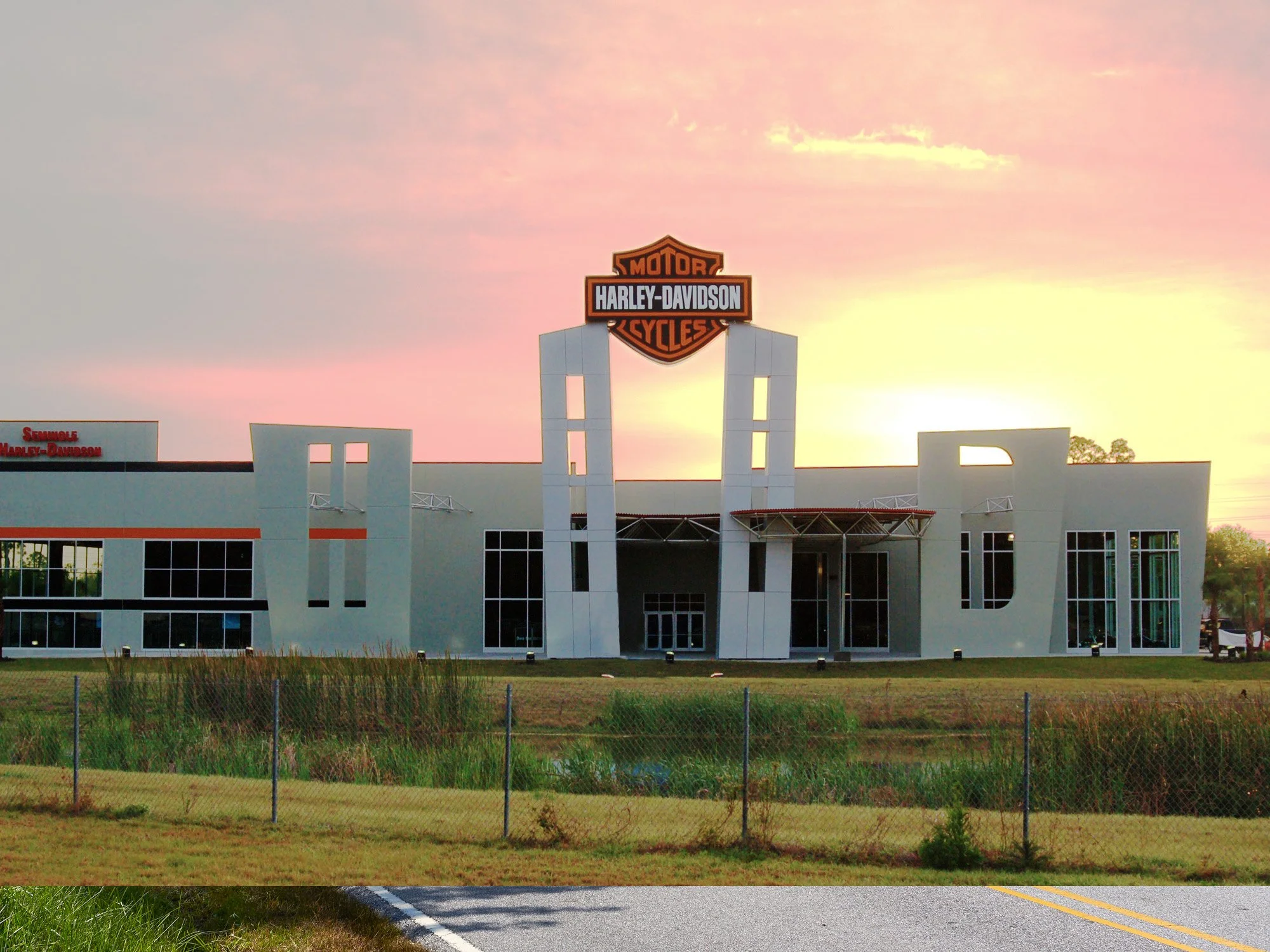 Outside Seminole Harley Davidson's building with the sun setting.