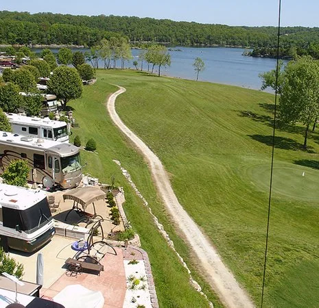 Elevated view of luxury Class A motorcoaches parked at Ozarks Luxury RV Resort.