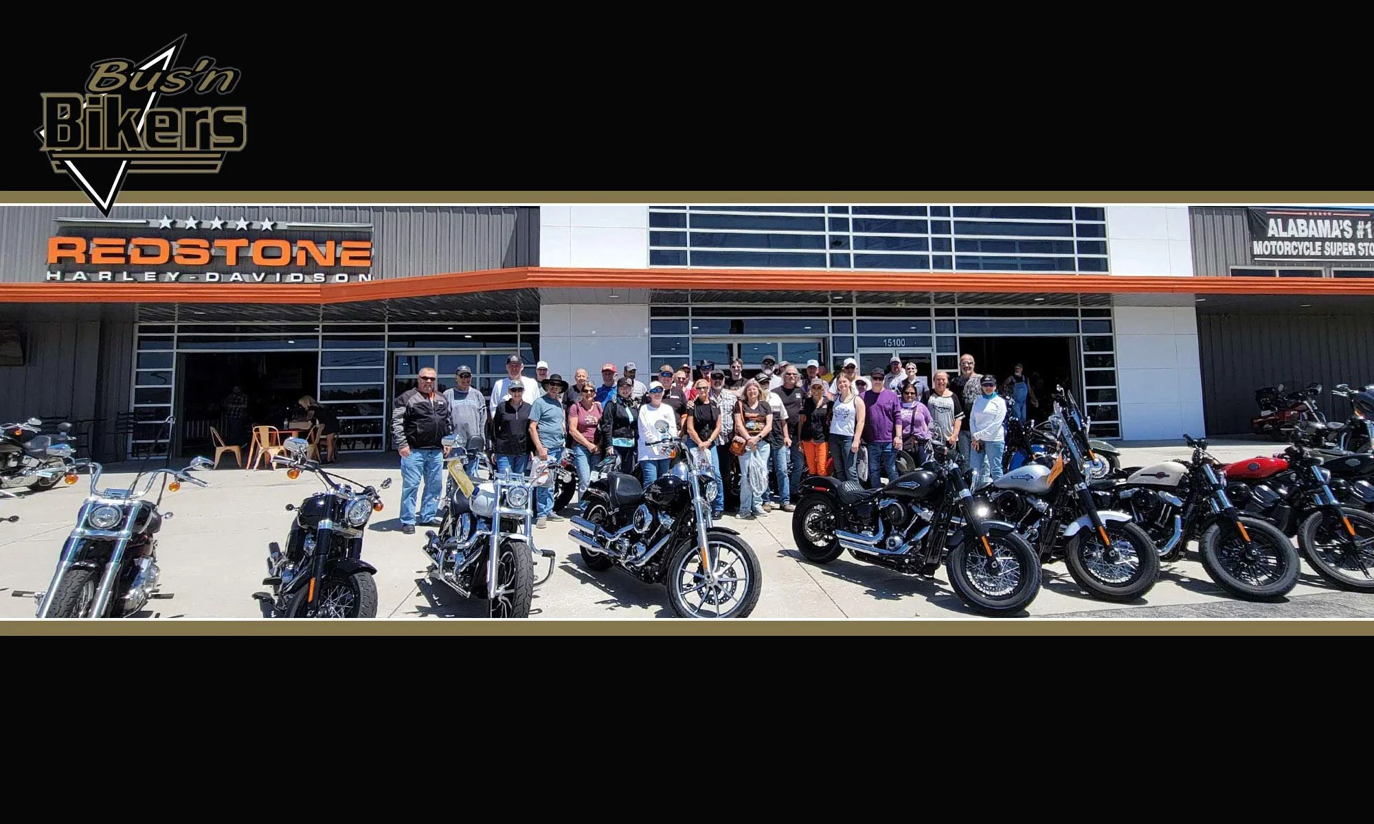 Bus'n Bikers members standing outside Redstone Harley Davidson.