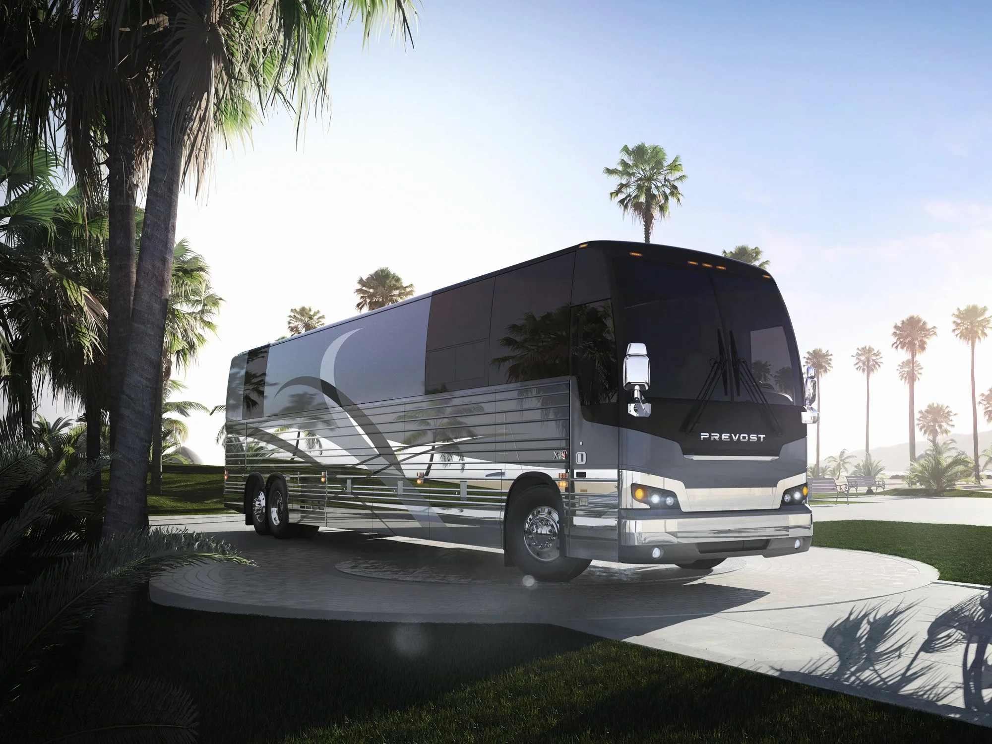 Prevost luxury motorcoach parked among palm trees at a modern resort setting, showcasing its stainless-steel exterior.