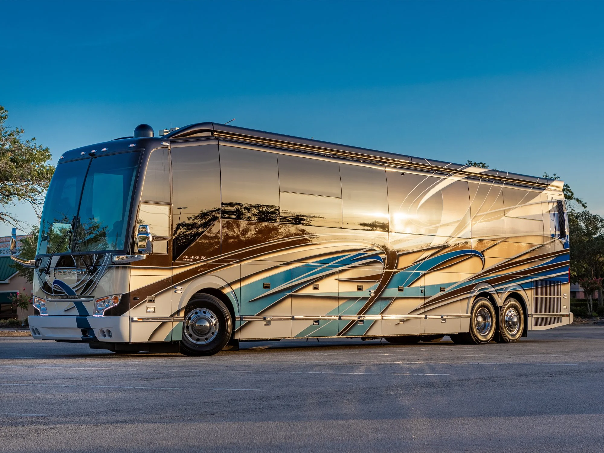 Luxury Prevost motorcoach exterior, custom paint job at sunset.
