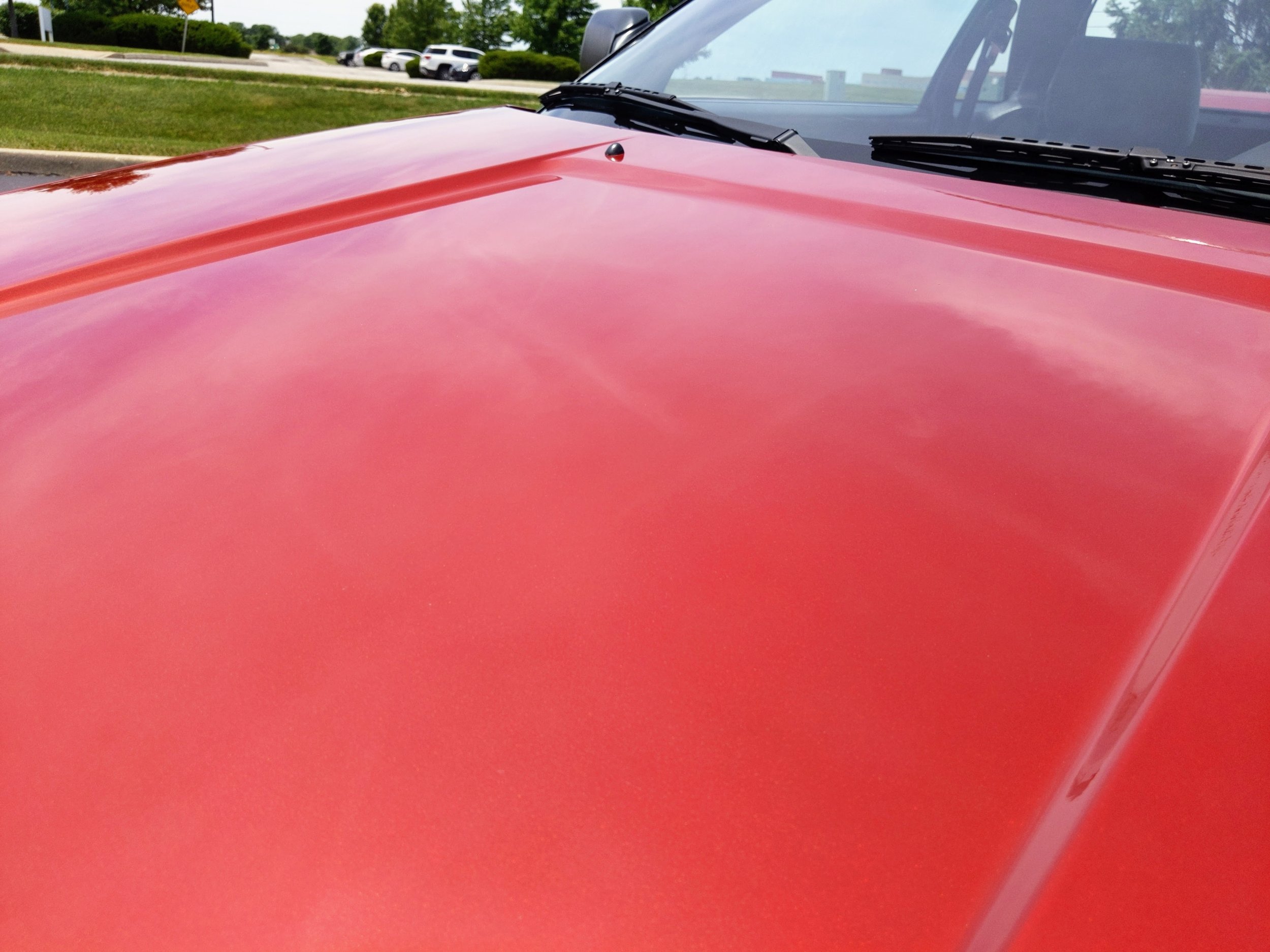 Modern house with wooden exterior and large glass windows on a stone staircase leading to a patio, set in a mountainous landscape with snow-capped peaks in the background.