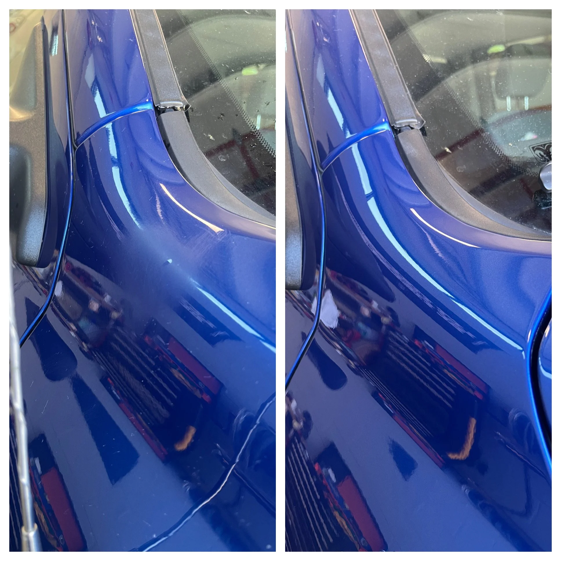 Close-up of a blue car's hood and windshield with a shiny surface, showing reflections of the surrounding garage.