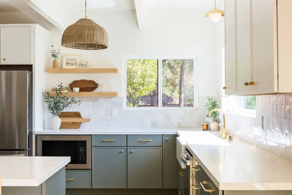Remodeled kitchen with sage-green cabinets, white counters, floating wood shelves and a woven pendant light, [near Felton, CA]