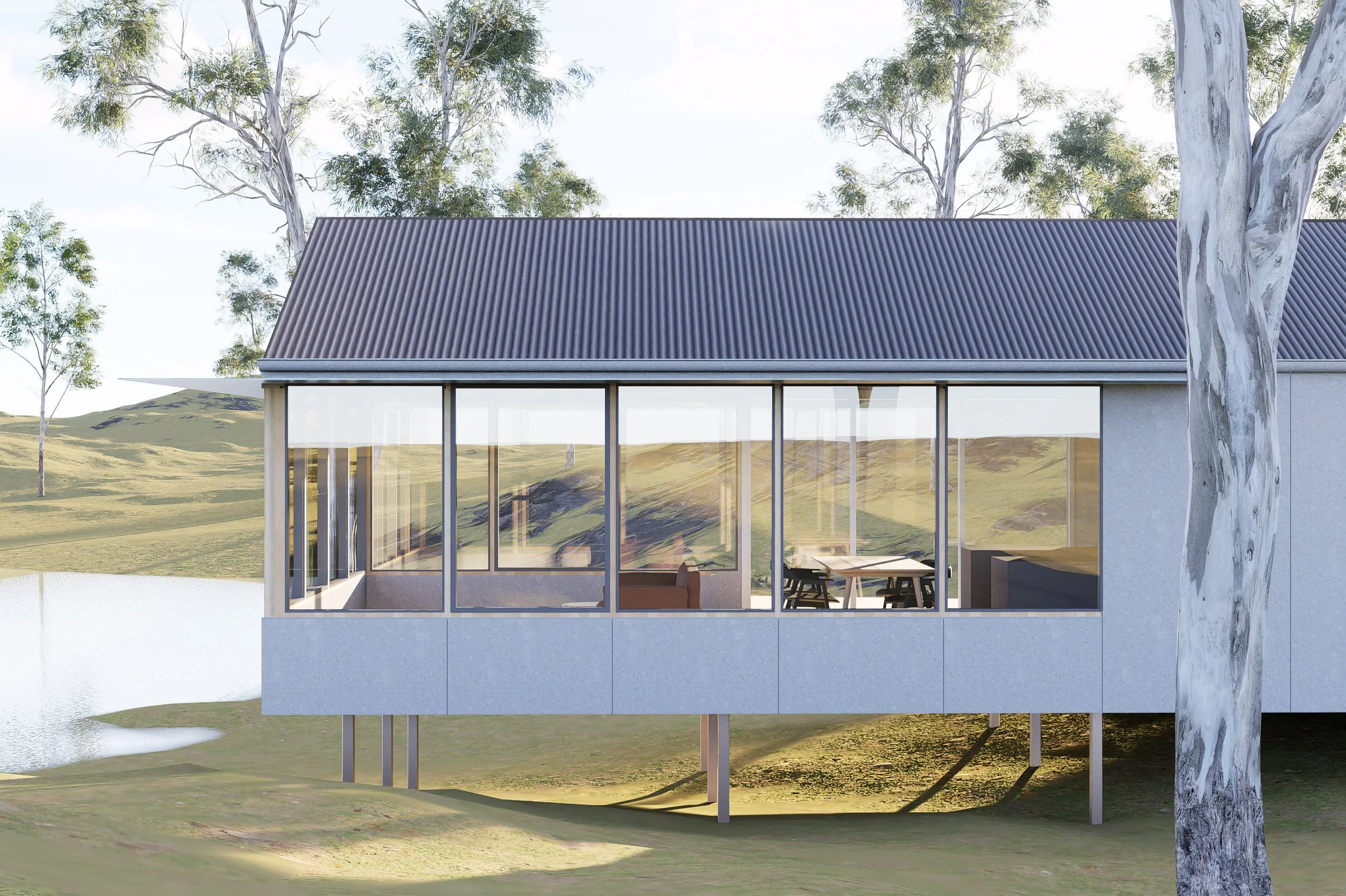 Modern house with large glass windows on stilts, situated in a grassy landscape with trees and a pond nearby.