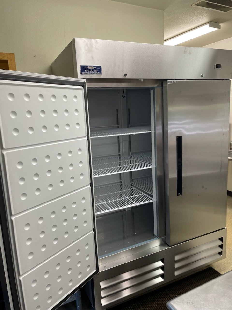 two commercial size refrigerators and a stand up freezer