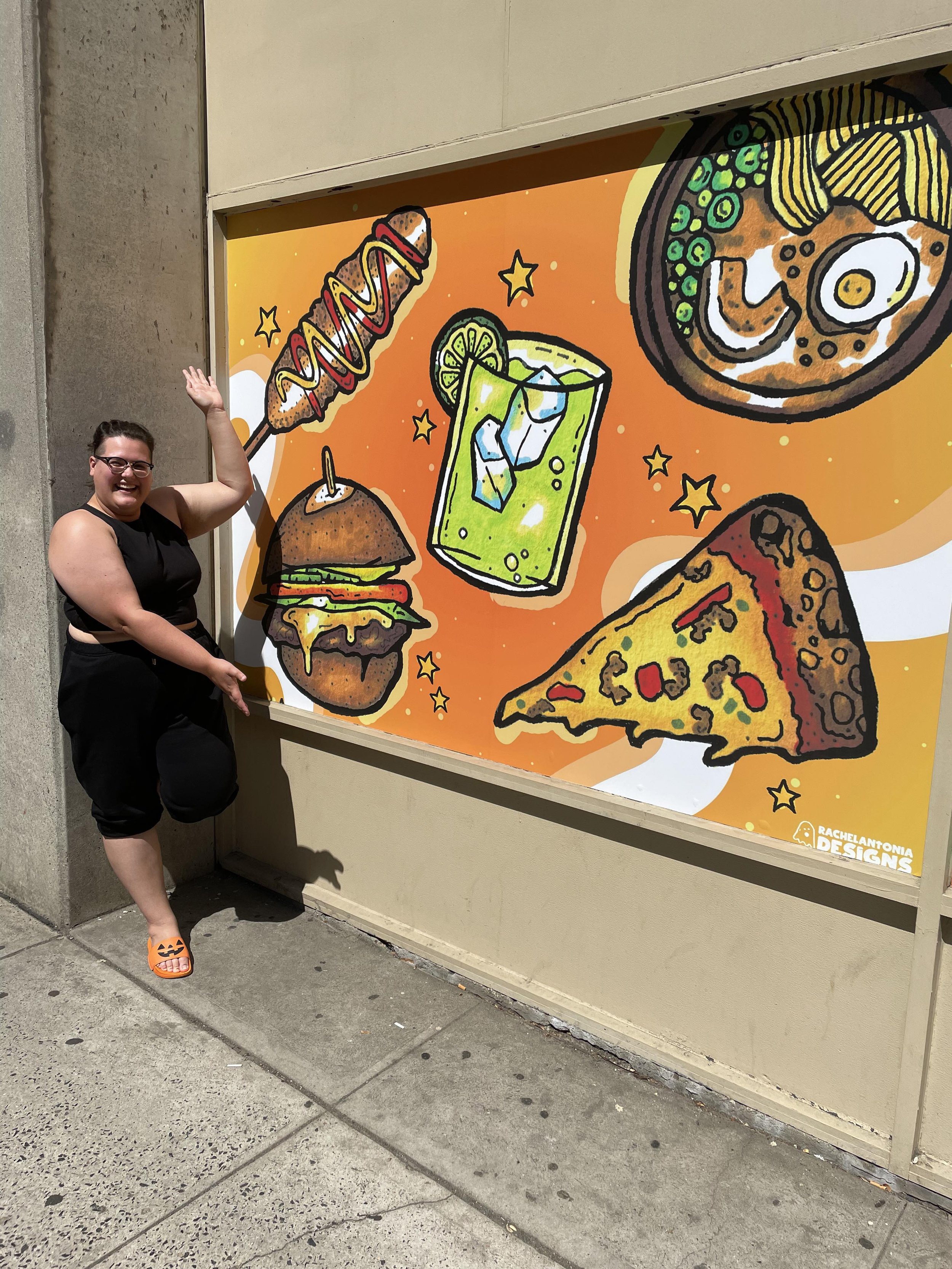 Rach standing outside the finished mural