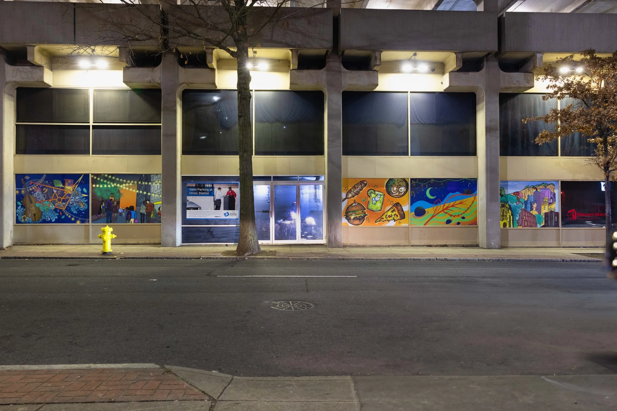 A view from across the street of the collection of New Haven Nightlife inspired murals
