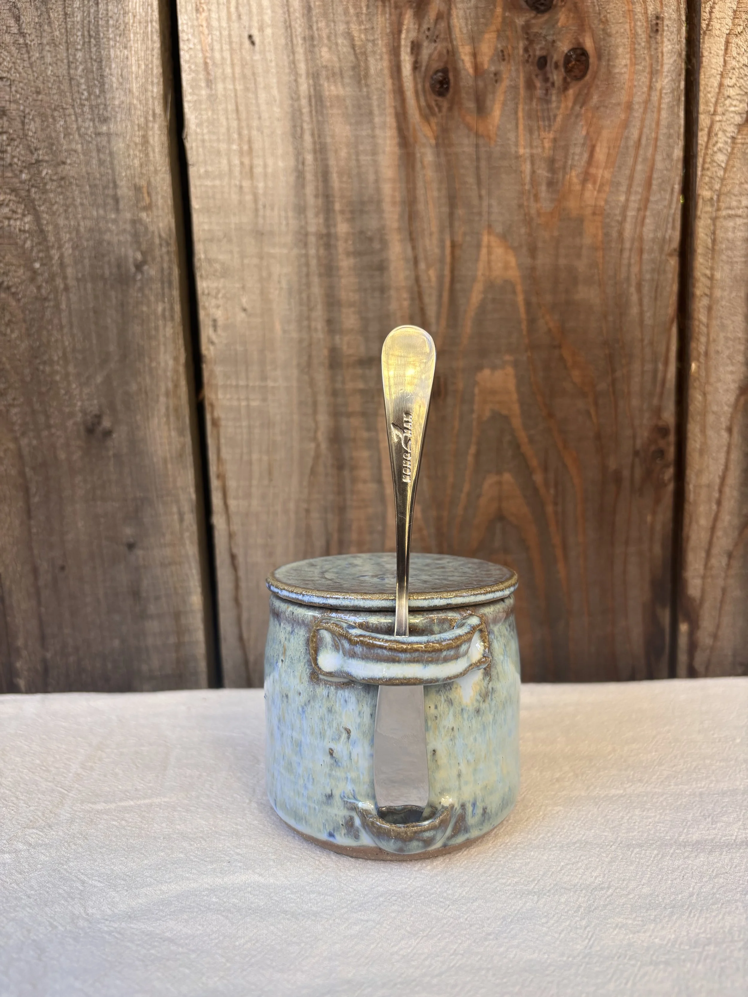 Handmade butter bell depicted with rustic style castille blue glaze