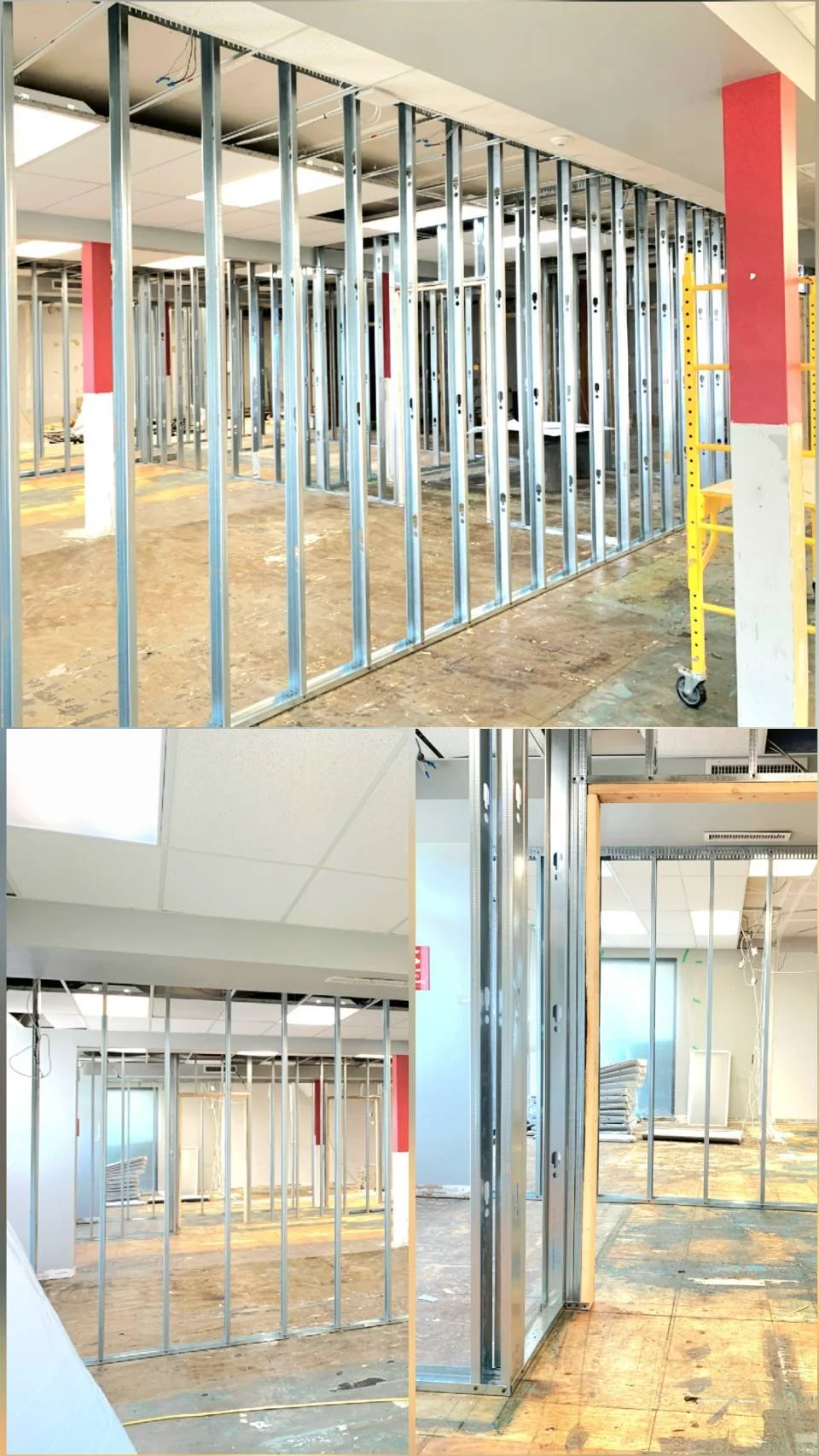 Interior view of a building under construction with metal wall framing, ceiling panels, and unfinished floors.