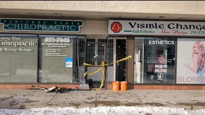 Finished construction work outside a chiropractic and wellness clinic with tools, buckets, and equipment on the ground.