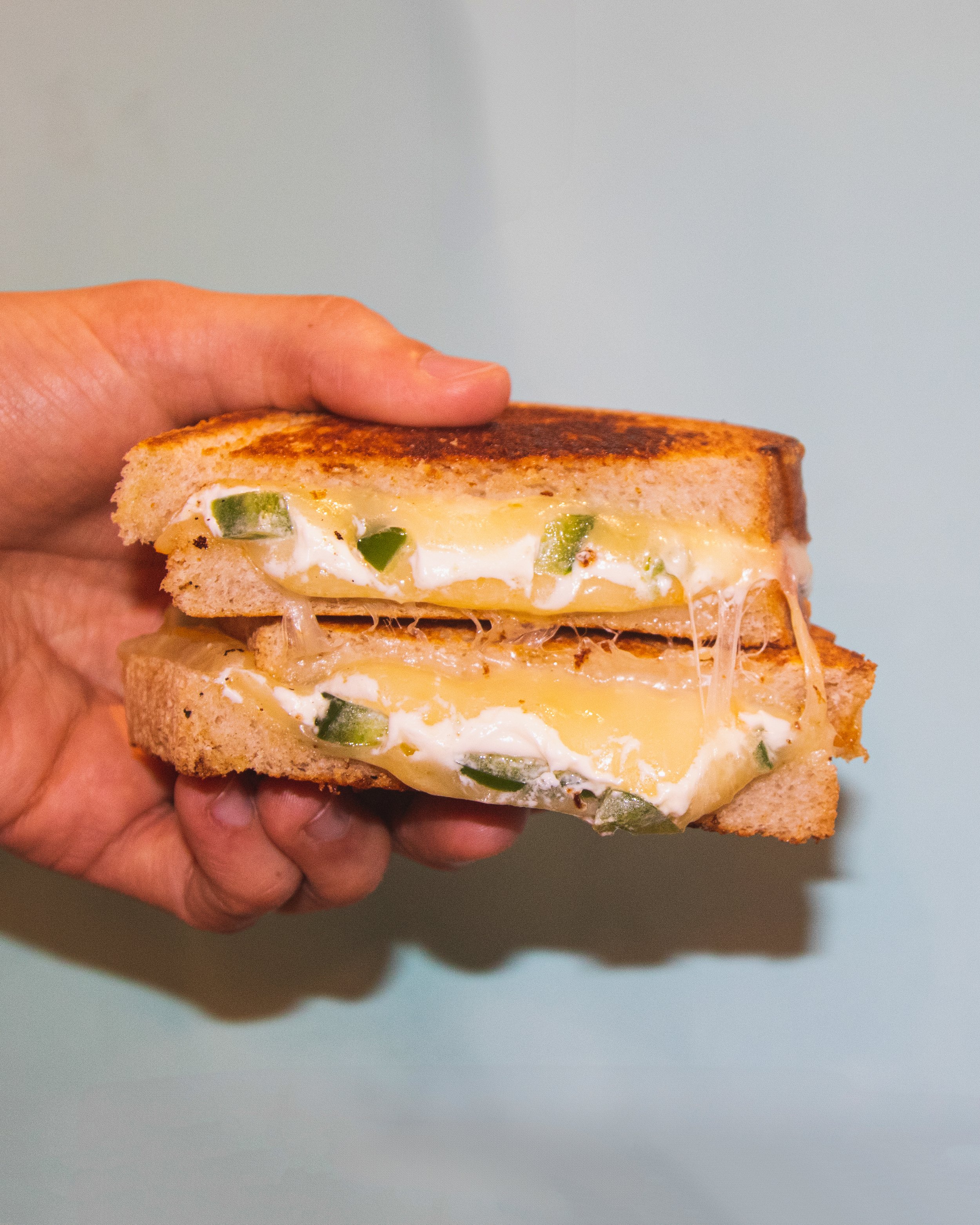 Our May special. Roasted Jalapeños. Cream Cheese. Cheddar. Sourdough.