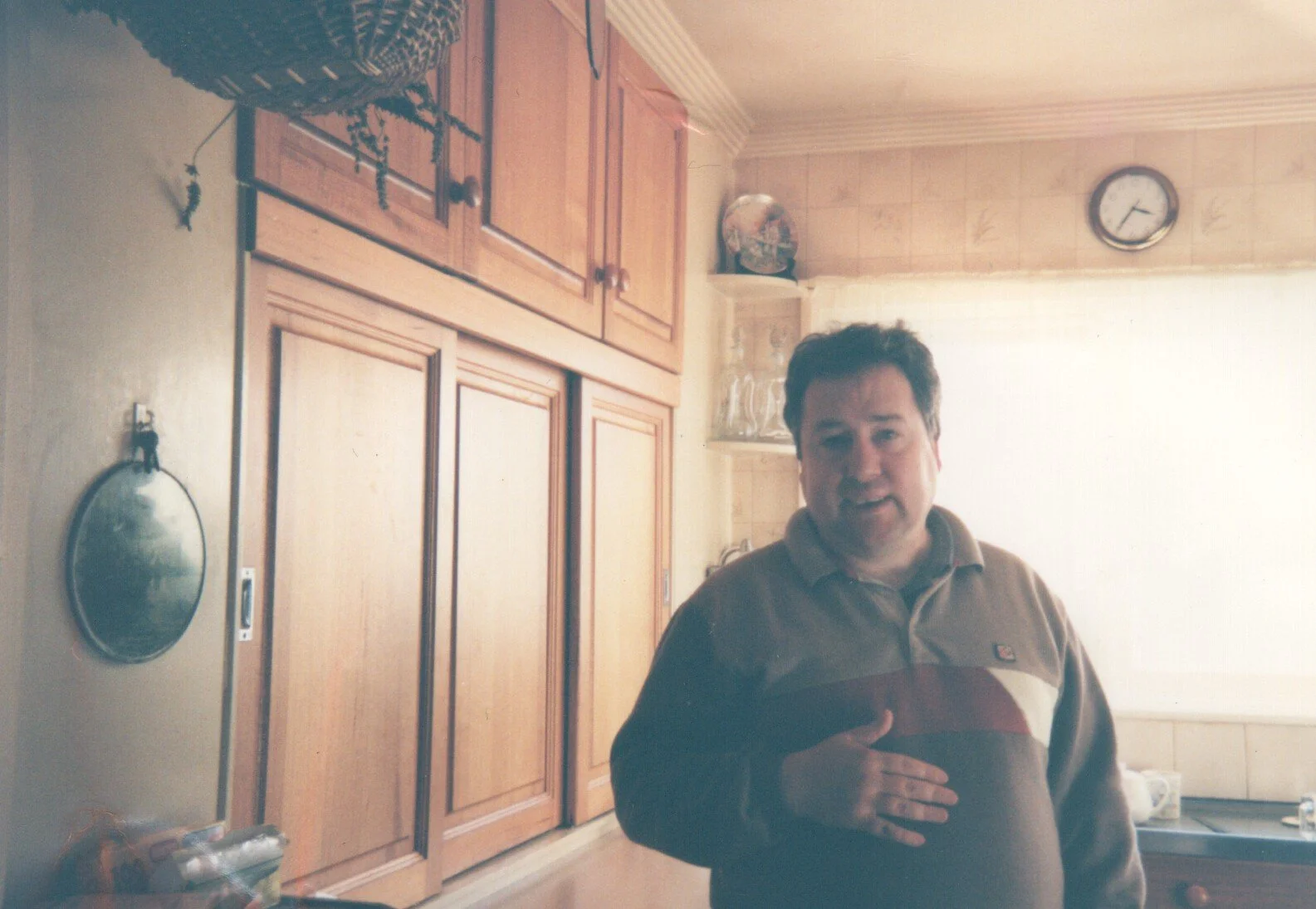 Artist Owen Roberts smiles at the camera in his kitchen.