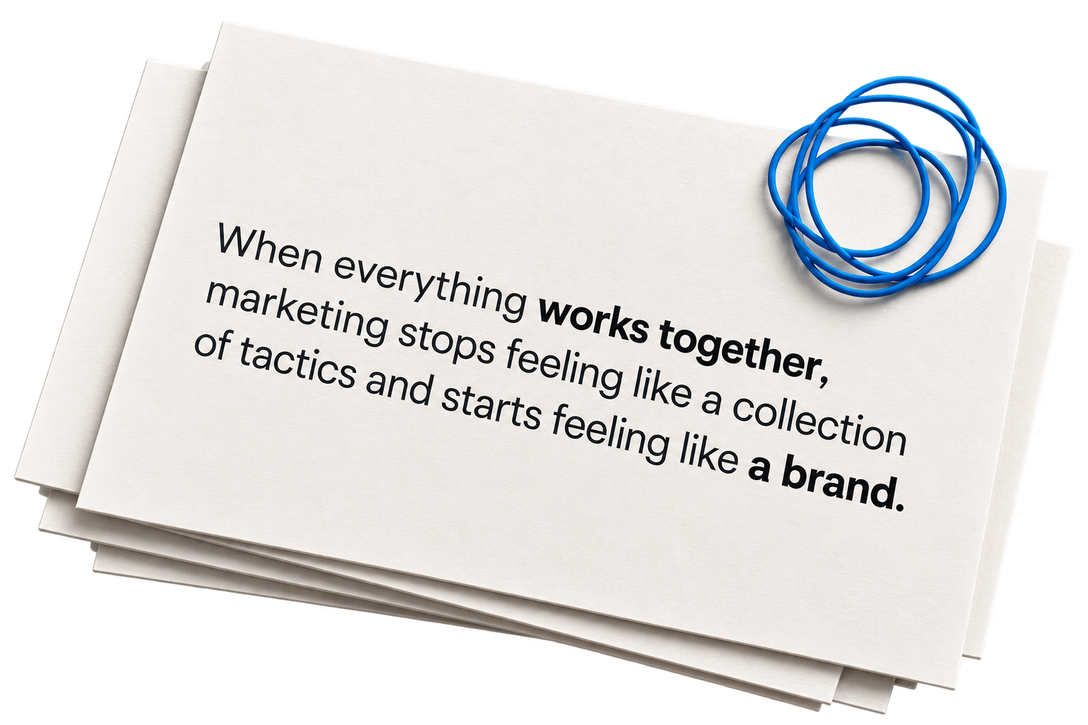 Cards and a paperclip that read: When everything works together, marketing stops feeling like a collection of tactics and starts feeling like a brand.
