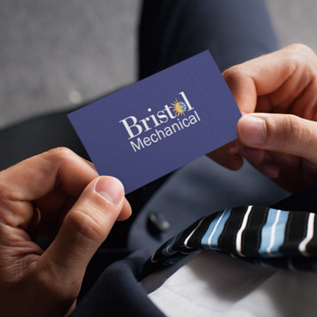 Person holding a business card for Bristol Mechanical, with a striped tie visible in the foreground.