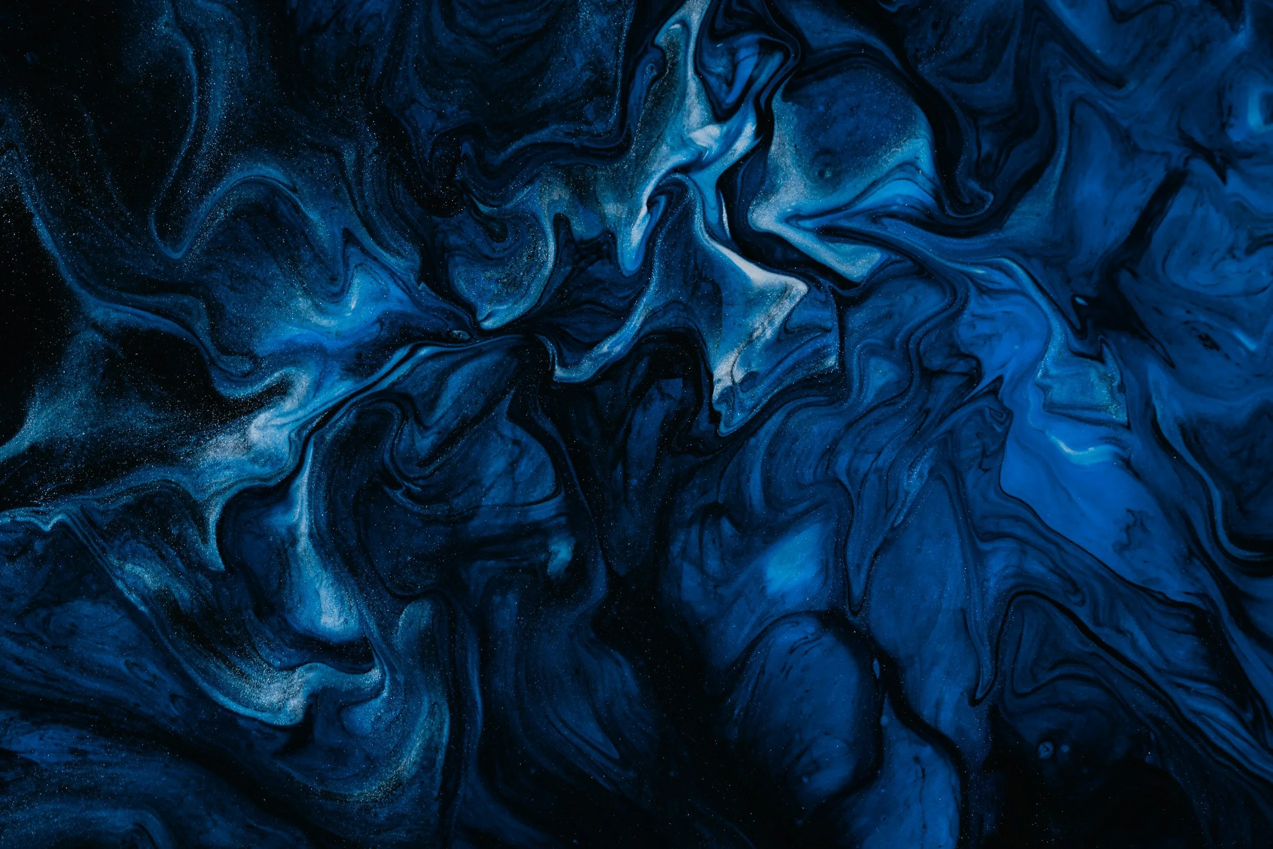 Abstract artwork with swirling shades of blue, black, and white.
