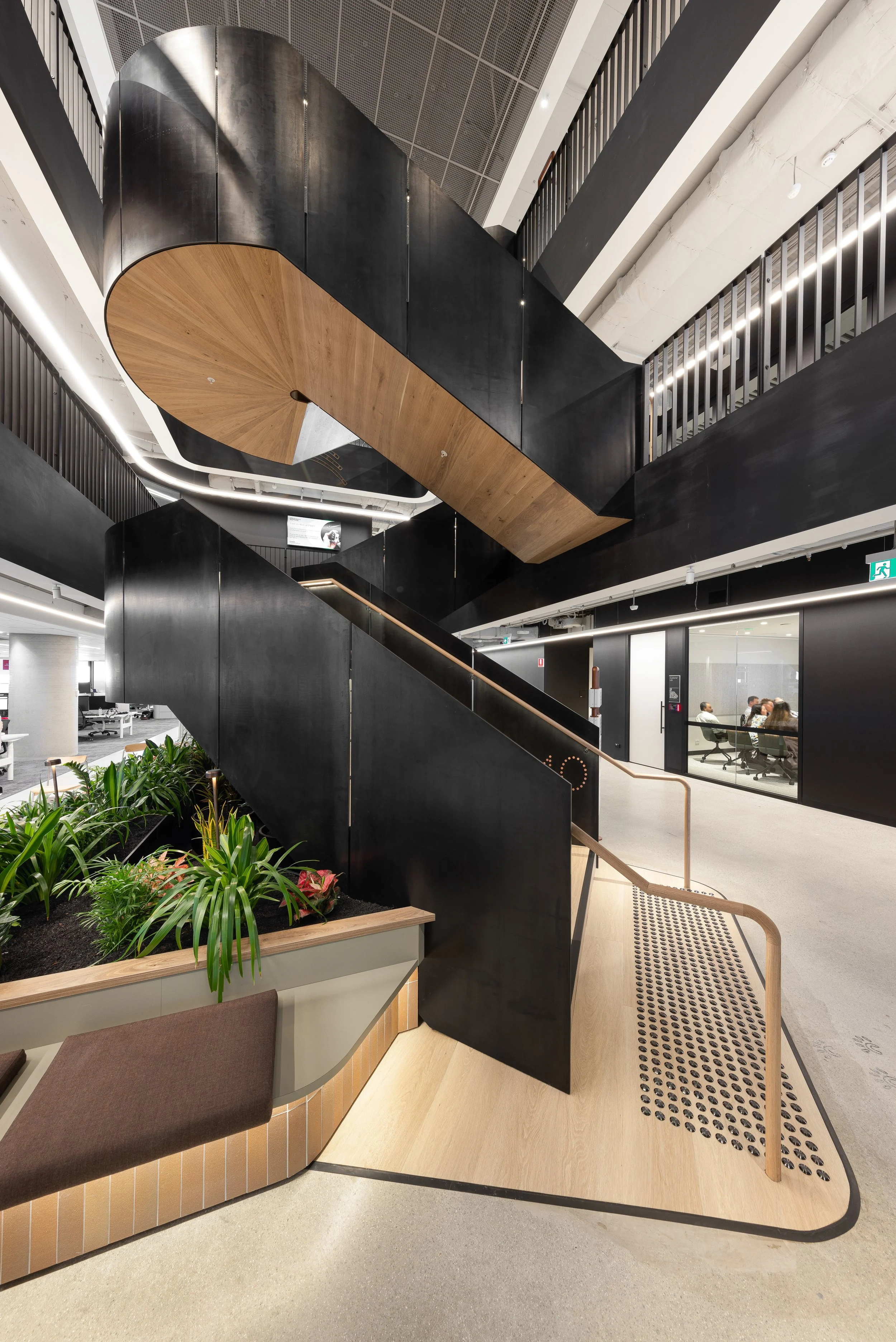 Black and white photo of modern curved building with sharp peaks and smooth metallic surface