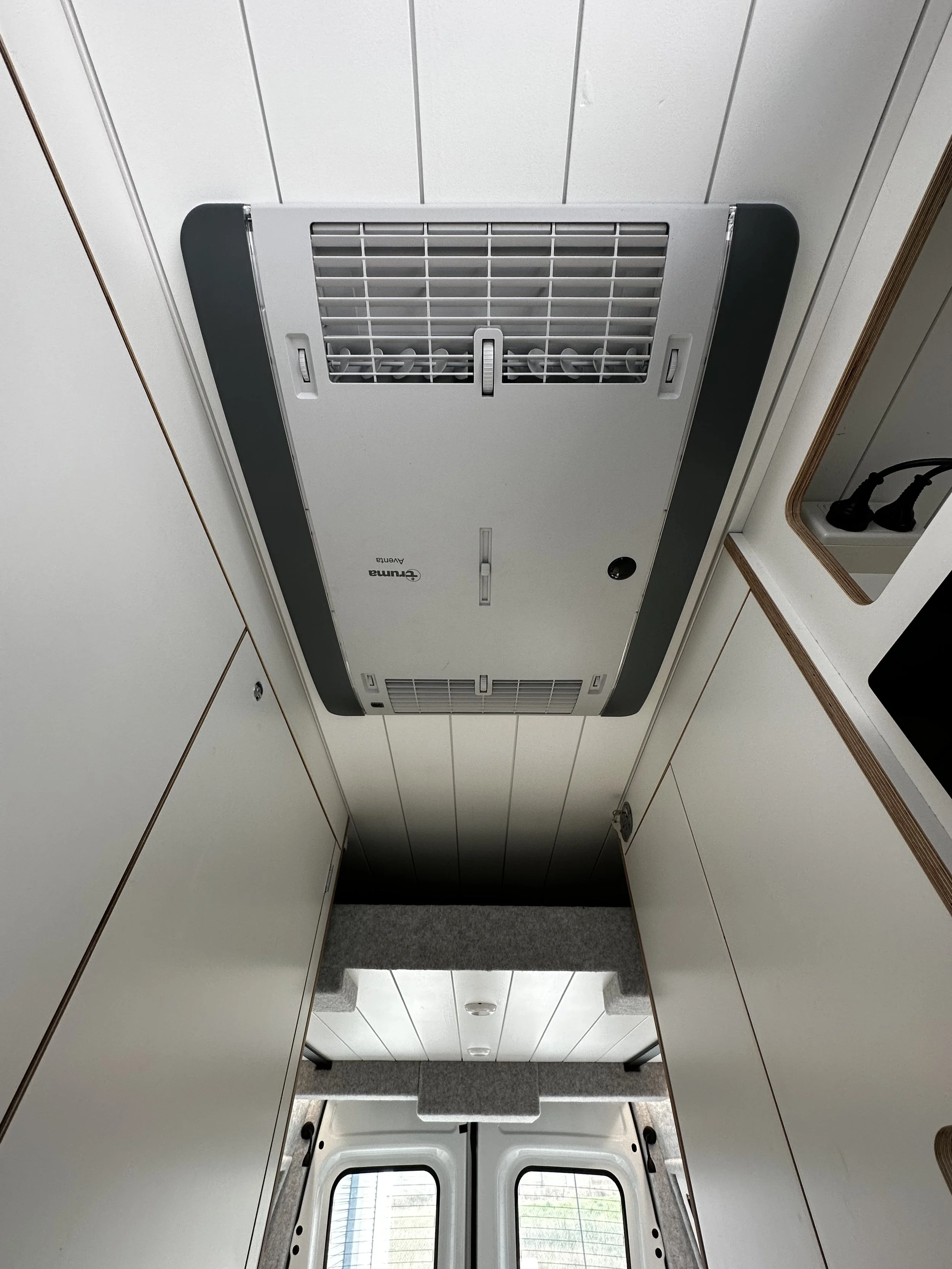 Ceiling vent in a small space, likely a camper or van interior.