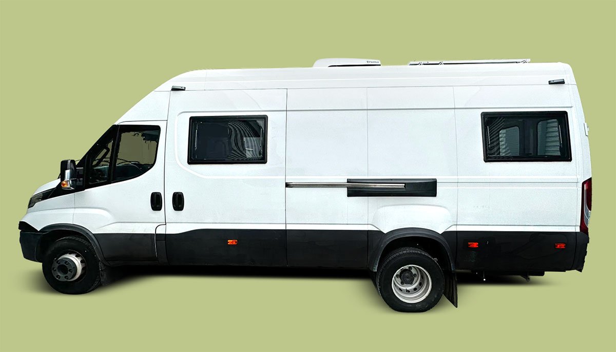 White camper van with black accents on a light green background.