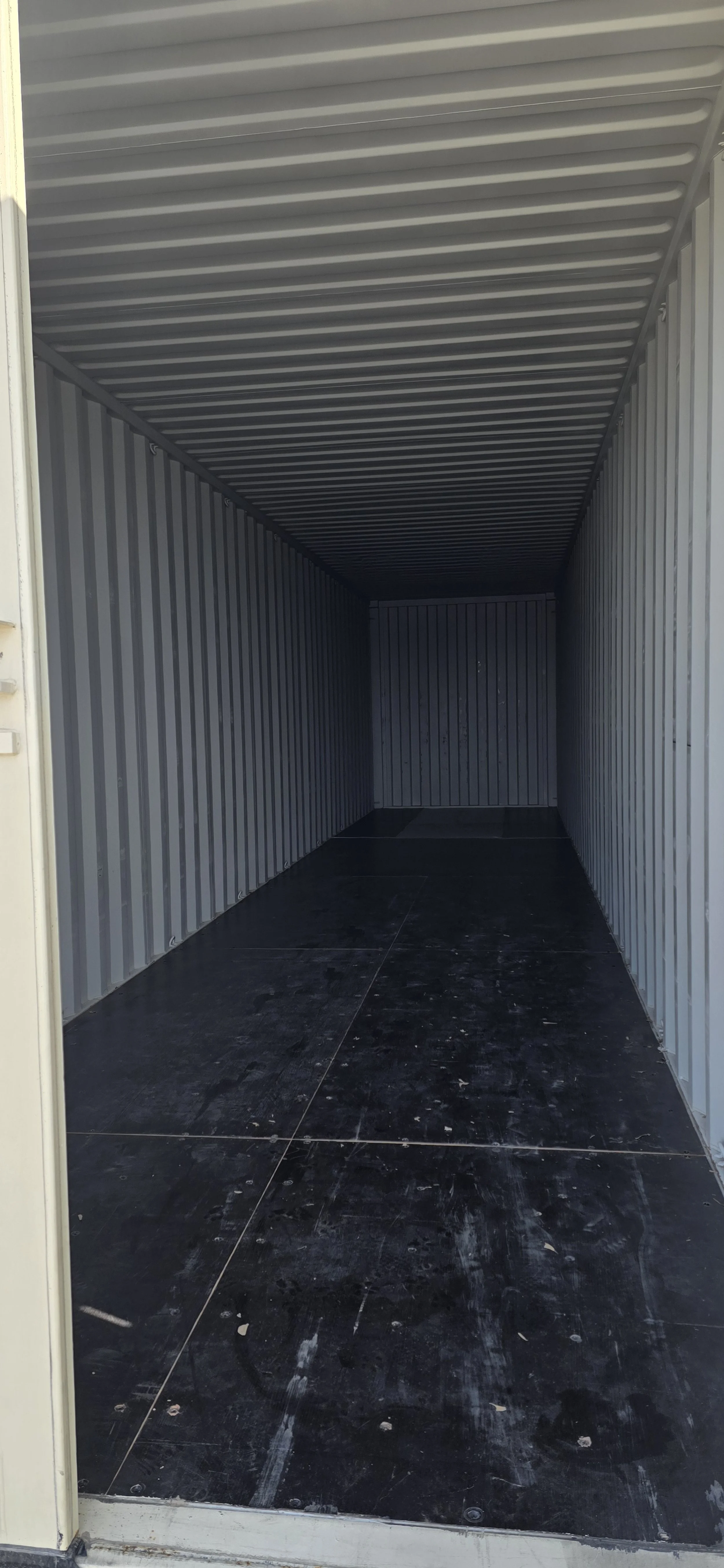 Interior of a New/one trip 40 ft storage container with steel walls and solid flooring, ideal for equipment or jobsite storage in Fort Worth, Texas.