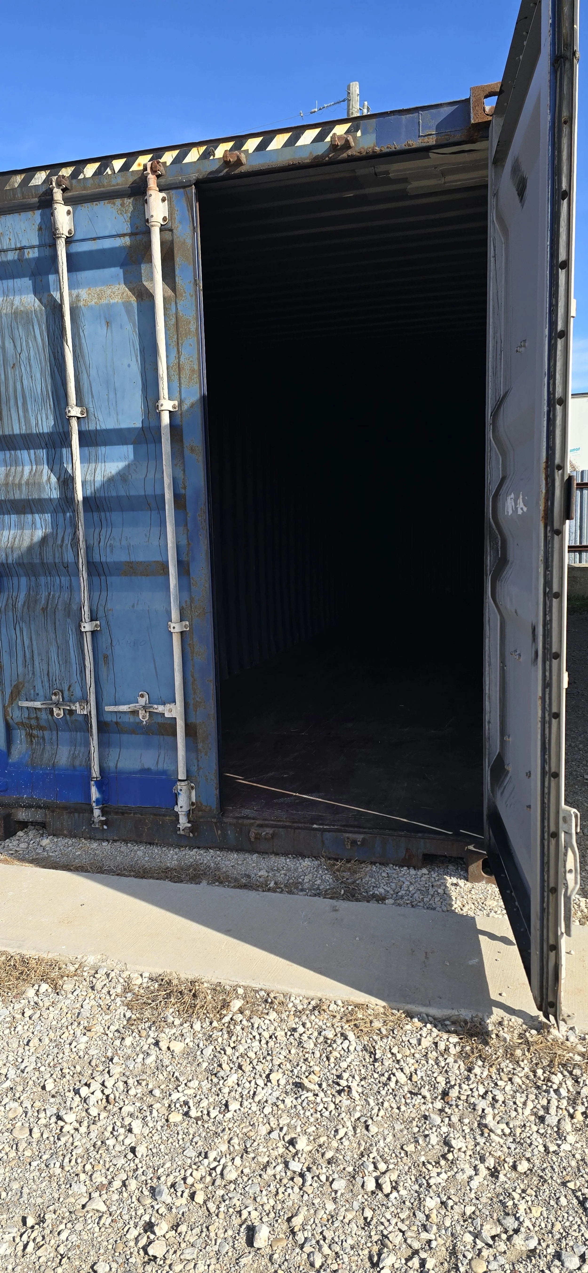 Open door view of a used 40 ft storage container in Fort Worth, TX showing clean steel interior and solid wood flooring.