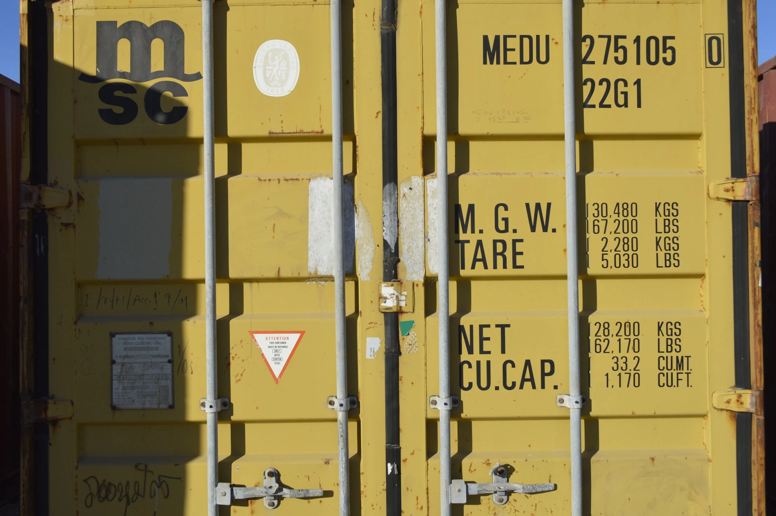 Close-up of double door locking mechanism on a used 20 ft steel storage container in Fort Worth, TX, showing durable hardware and solid construction.