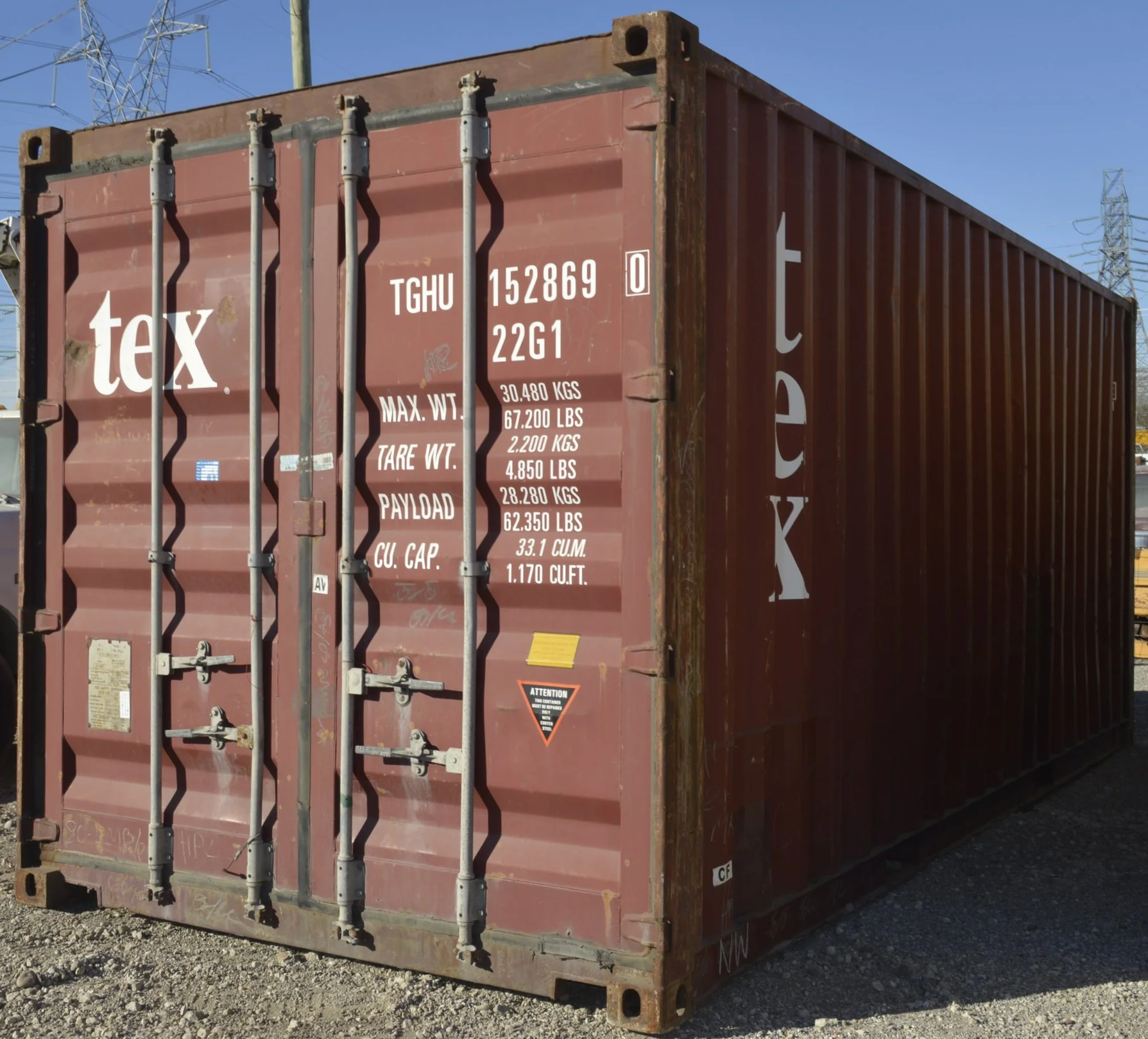 Side angle exterior view of a used 20 ft shipping container in Fort Worth, TX showing corrugated steel walls and wind and water tight condition.