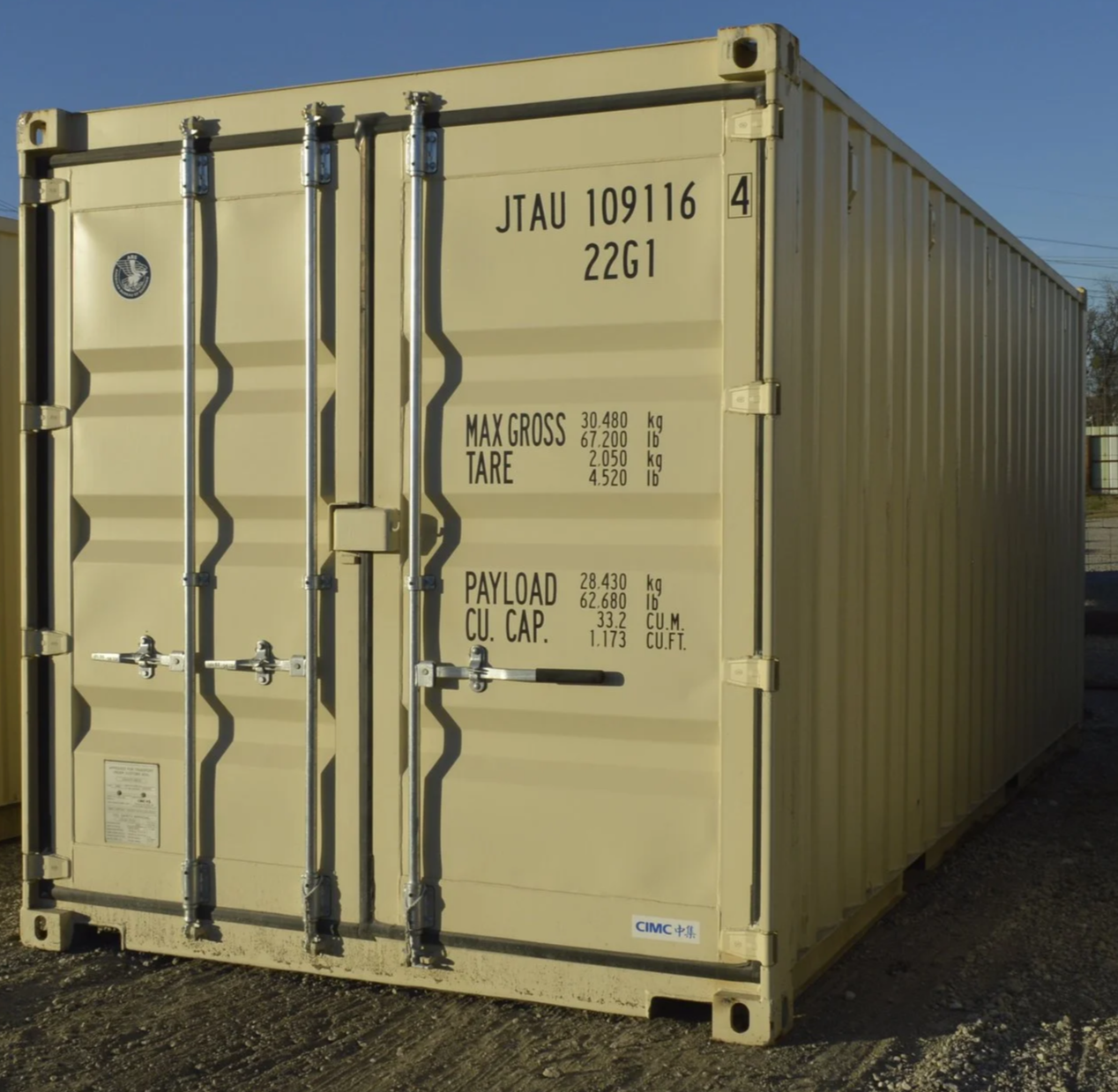 Side angle exterior view of a one trip 20 ft shipping container in Fort Worth, TX showing corrugated steel walls and wind and water tight condition.