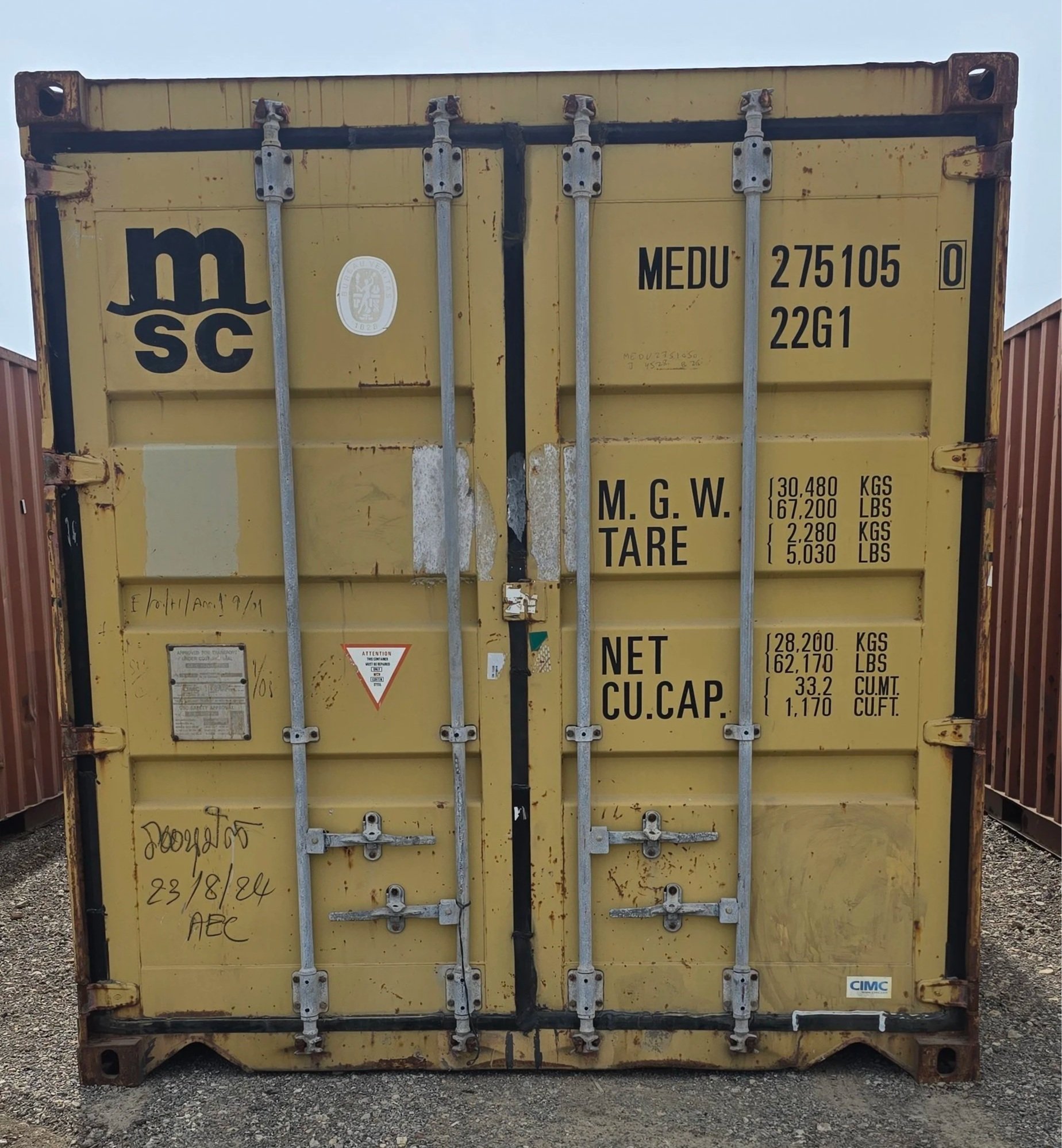 Yellow used 20ft shipping container front view with closed double doors