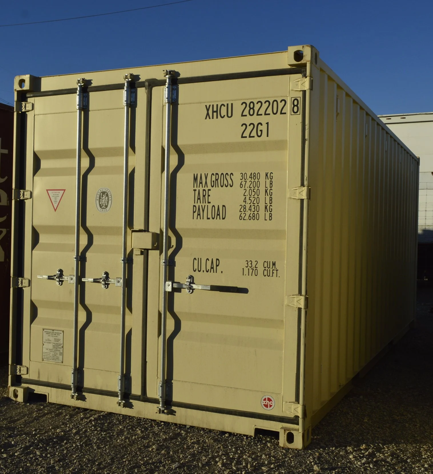 Side angle exterior view of a one trip 20 ft shipping container in Fort Worth, TX showing corrugated steel walls and wind and water tight condition.