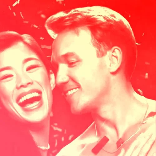 A smiling woman and man laughing together in a festive red background. Magic Mike Live. Sahara Las Vegas. Channing Tatum.
