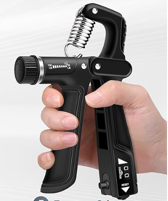 A hand holding a black handheld carbonation or dispensing device with a silver coil coil above it.