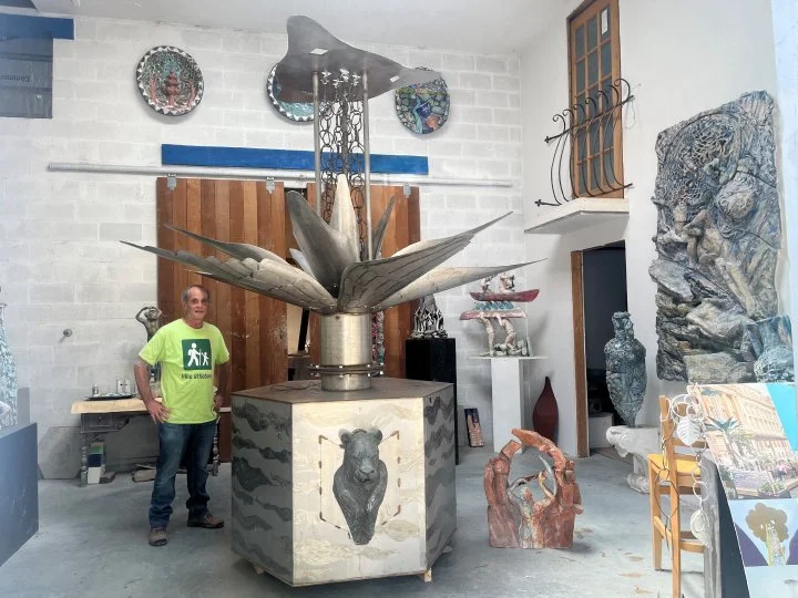 Brian Hatch, President of Riverwalk Arts, stands next toRainkeep sculpture in Allison Newsome studio