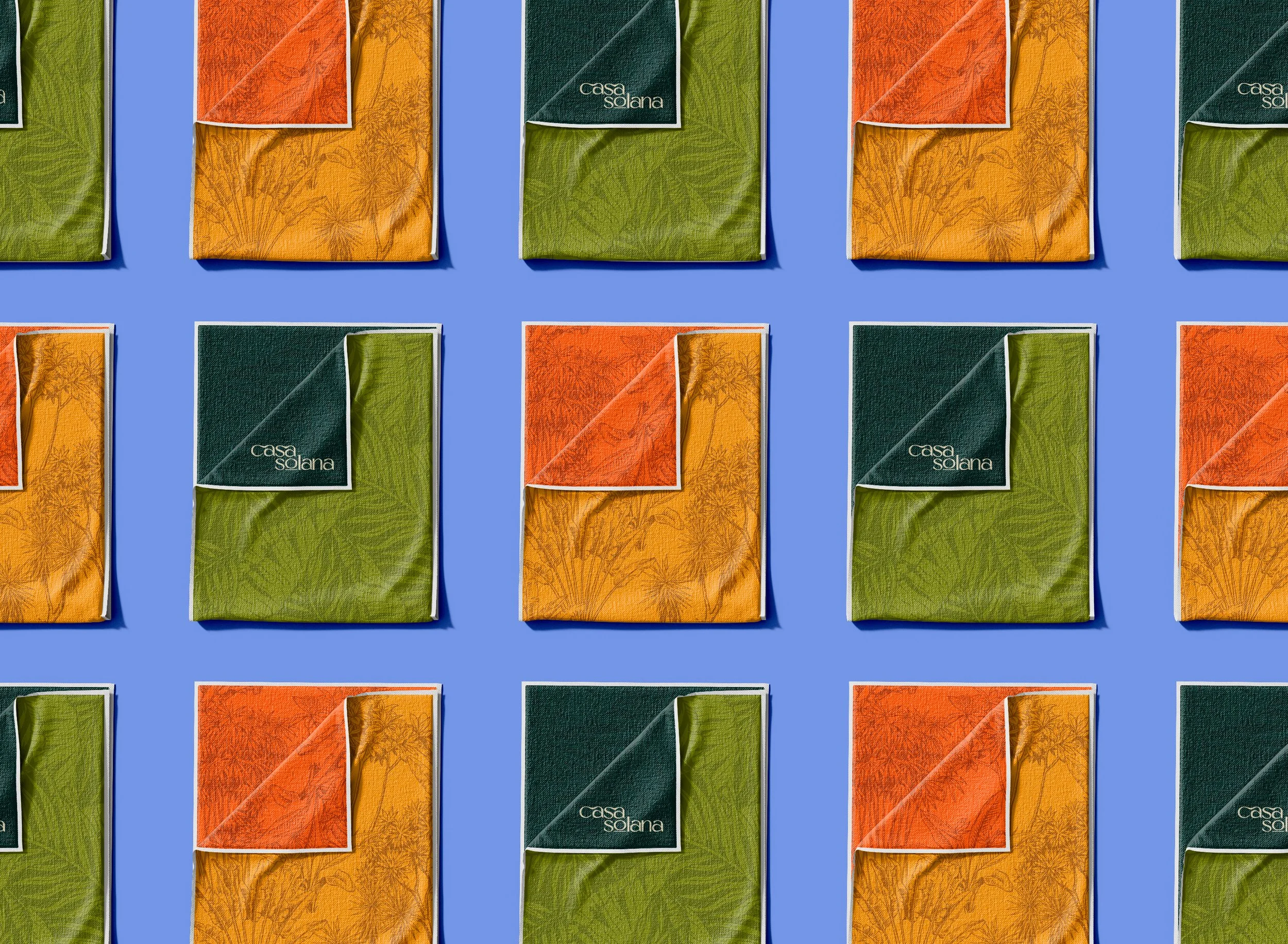 Multiple packs of Casa Solana tissues in green, orange, and yellow colors arranged in a grid pattern on a blue background.