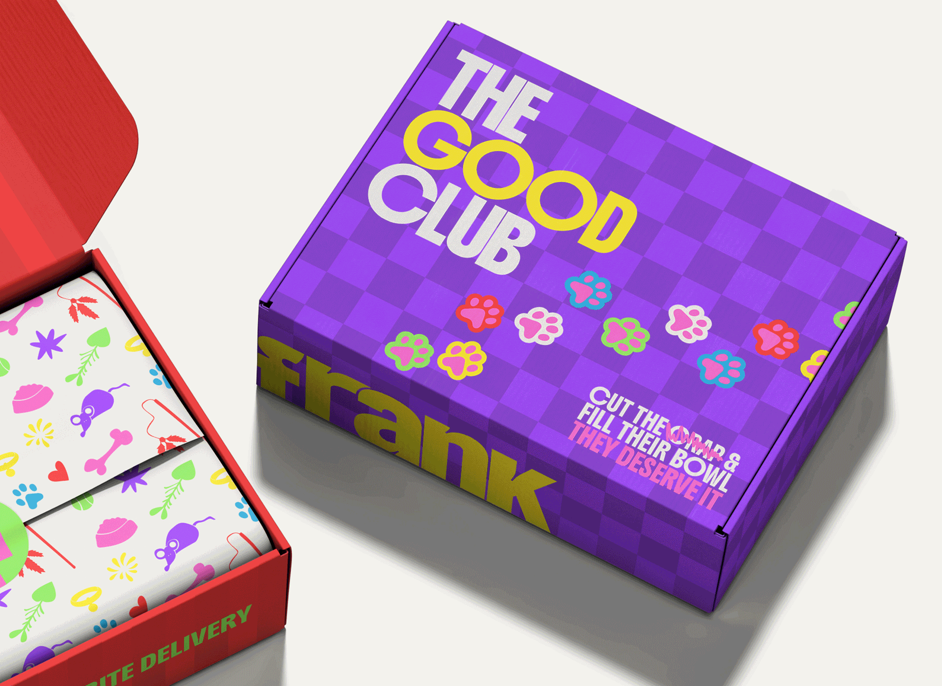 A purple box labeled 'The Good Club' with colorful flower illustrations and the phrase 'Cut the spam & fill their bowl. They deserve it.' next to a partially open red box containing wrapped items with pet-themed designs.