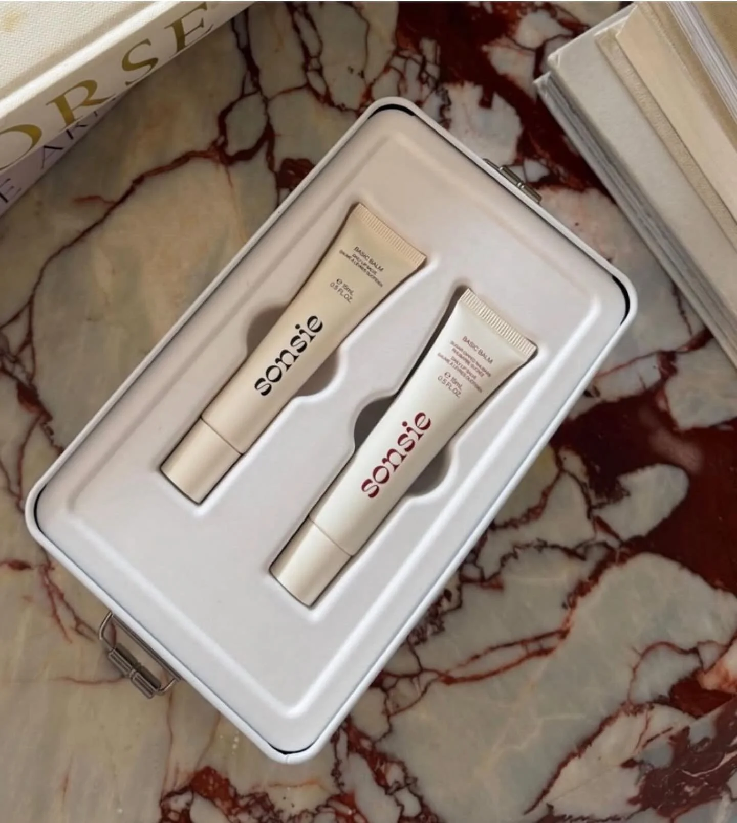 Unboxed to perfection 🖤 diggingthis sustainable reusable tin for Sonsie&rsquo;s sugar dipped rhubarb and basic balm lip duo 💋