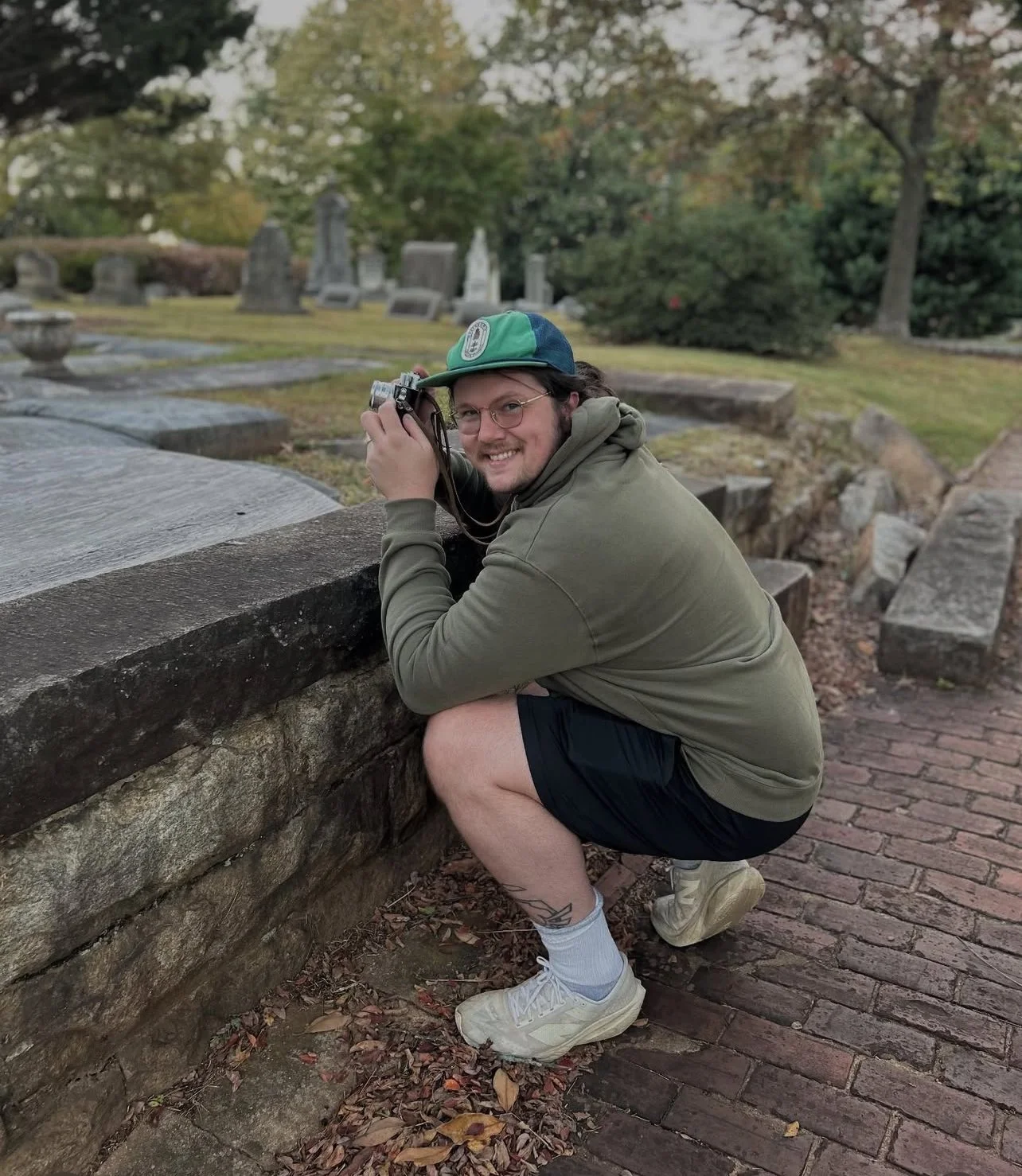 Photographer Chasen Rivard takes a photo at Atlanta's Historic Oakland Cemetary