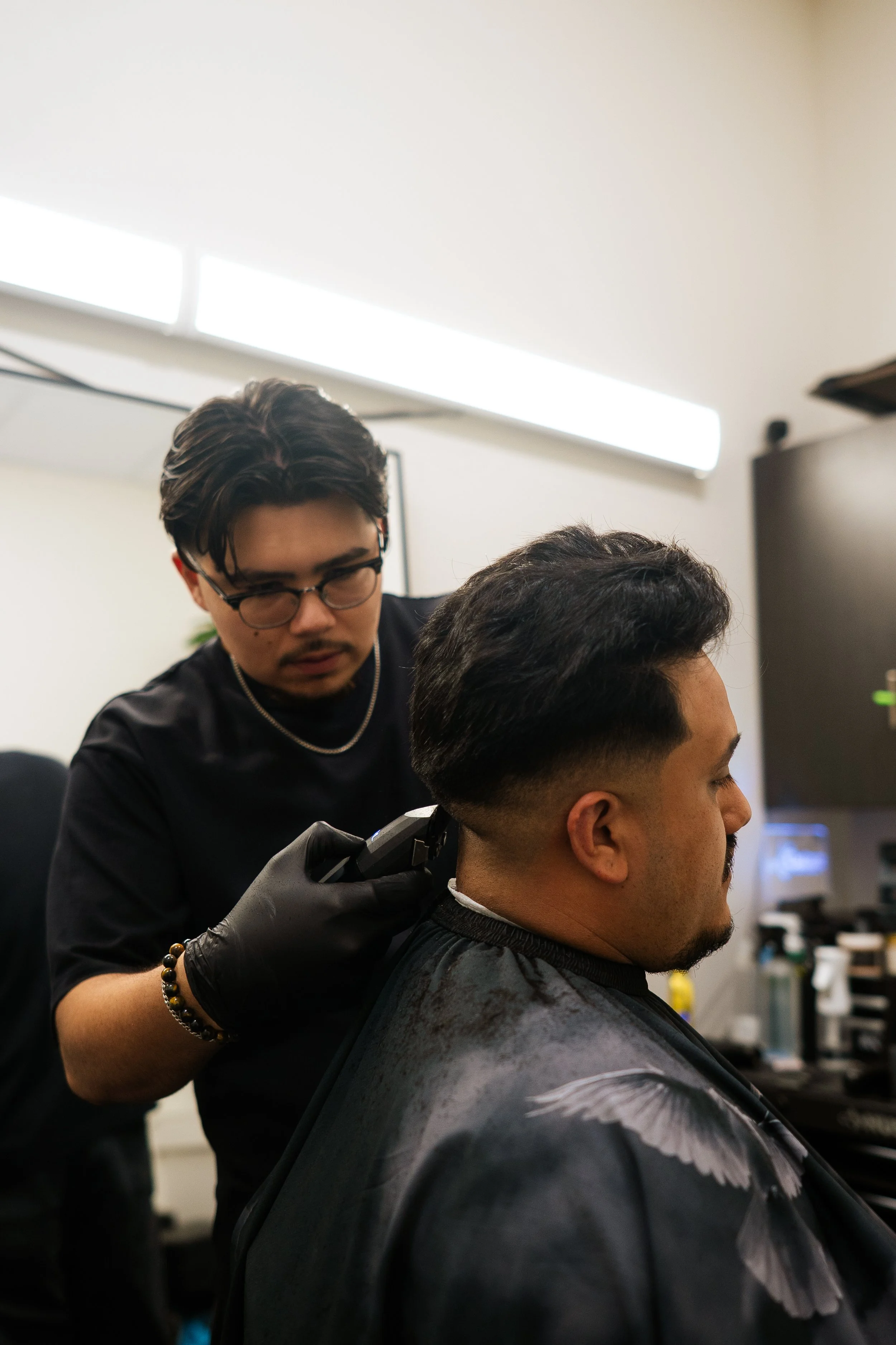 Barber giving a man a haircut in a barbershop