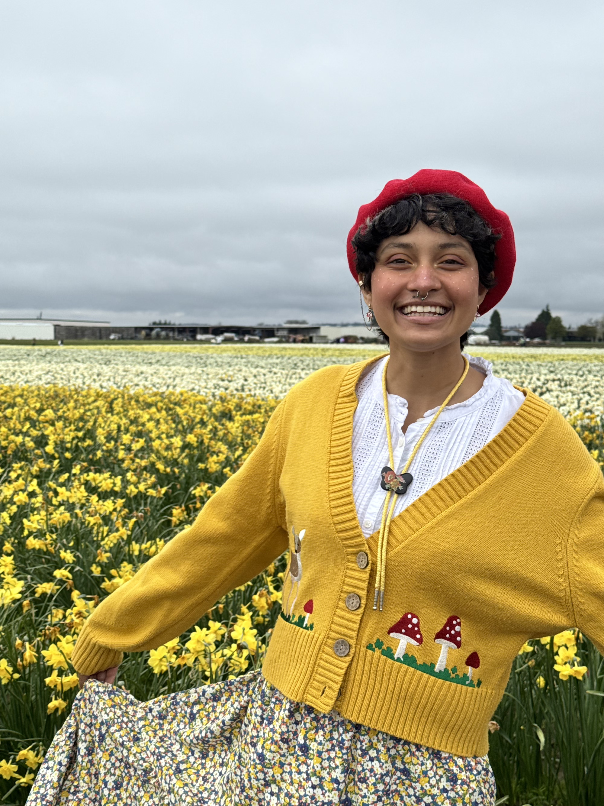 Photo of Ananya Bhat in front of daffodils