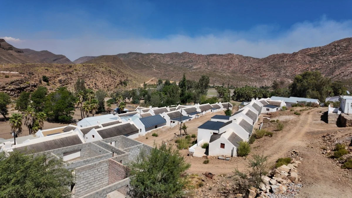 Wupperthal village nestled deep in the Cederberg Mountains, South Africa, with rebuilt white cottages following the 2019 fire in a historic rooibos farming community