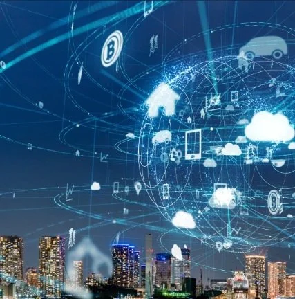 Digital cityscape with cloud computing and blockchain icons and a futuristic network overlay in the sky.