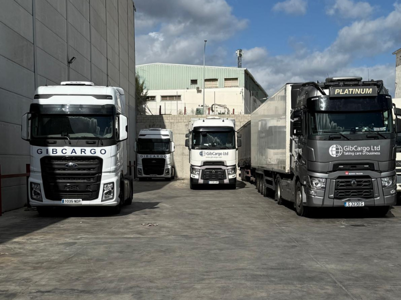 Four GIBCargo trucks parked in an outdoor loading area.