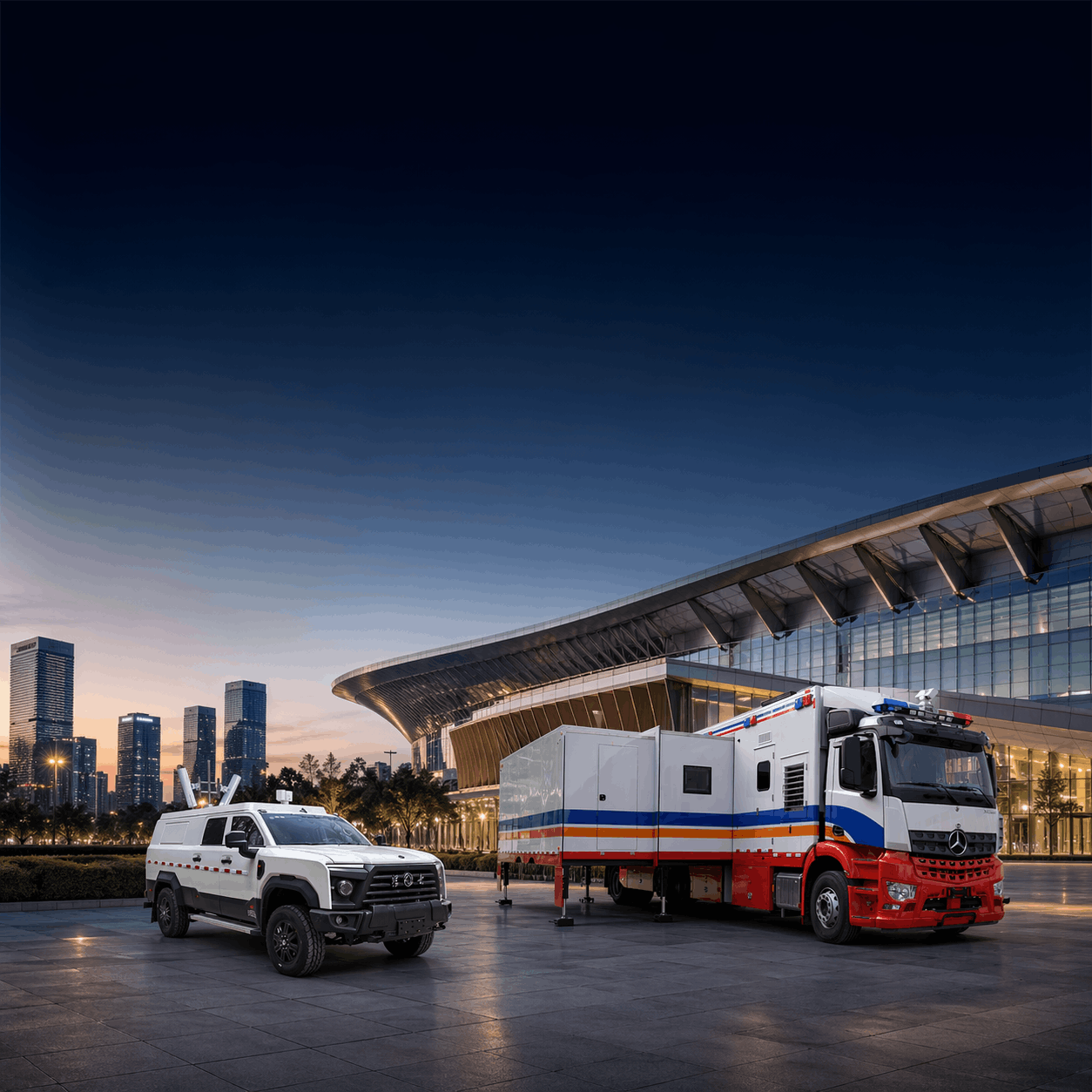 Two emergency vehicles parked outside a modern building during dusk, with tall city buildings in the background