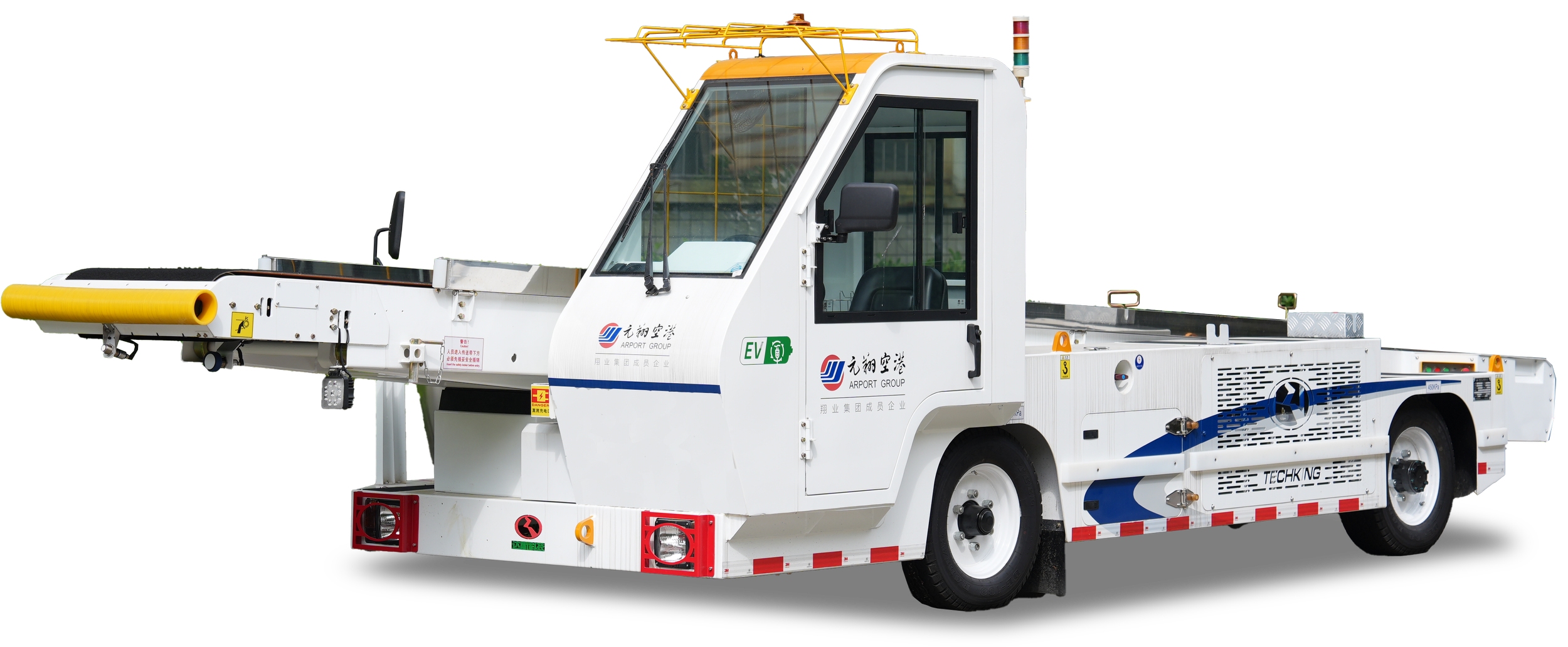 A white airport luggage conveyor vehicle with various colored markings, logos, and safety labels, used for transporting baggage at an airport.