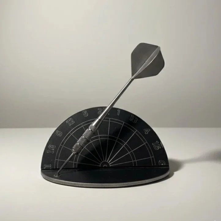 Un jeu de fléchettes avec le tableau et une fléchette en équilibre dessus.