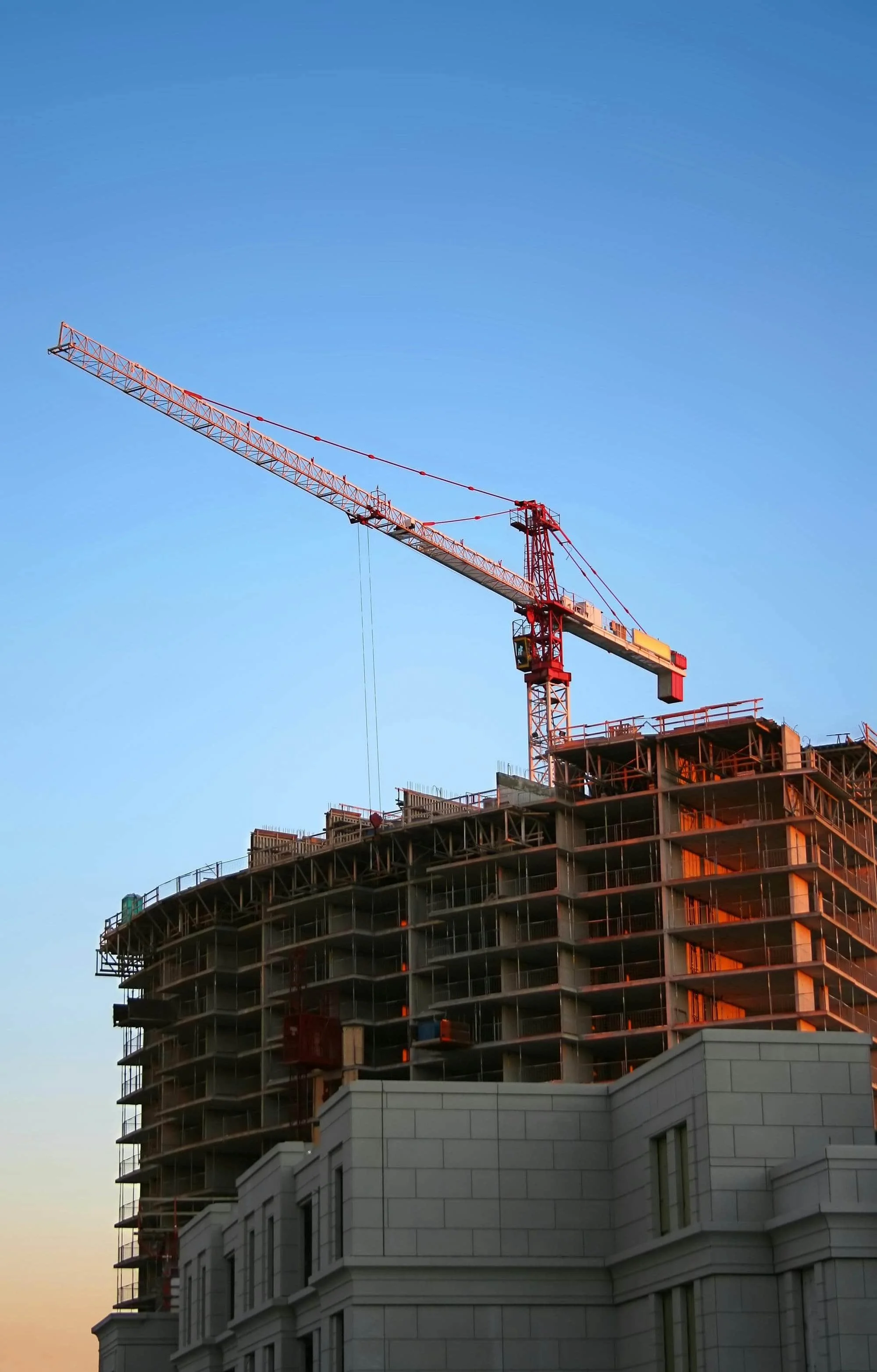 A construction crane building a large-scale commercial property development.