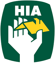 A green emblem featuring a white hand holding a house, with the text 'HIA' above it.
