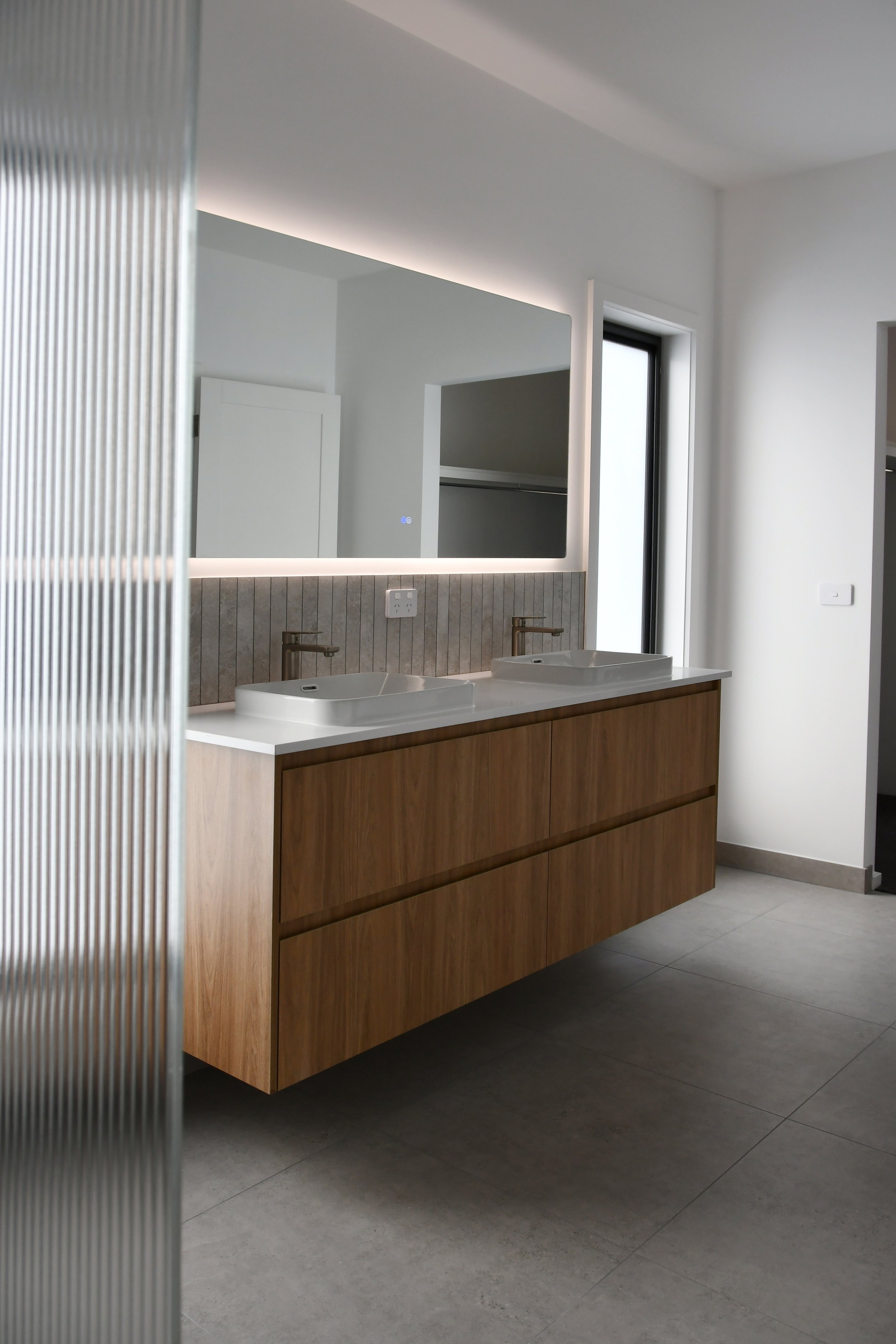 Sleek bathroom, floating vanity, fluted shower screen