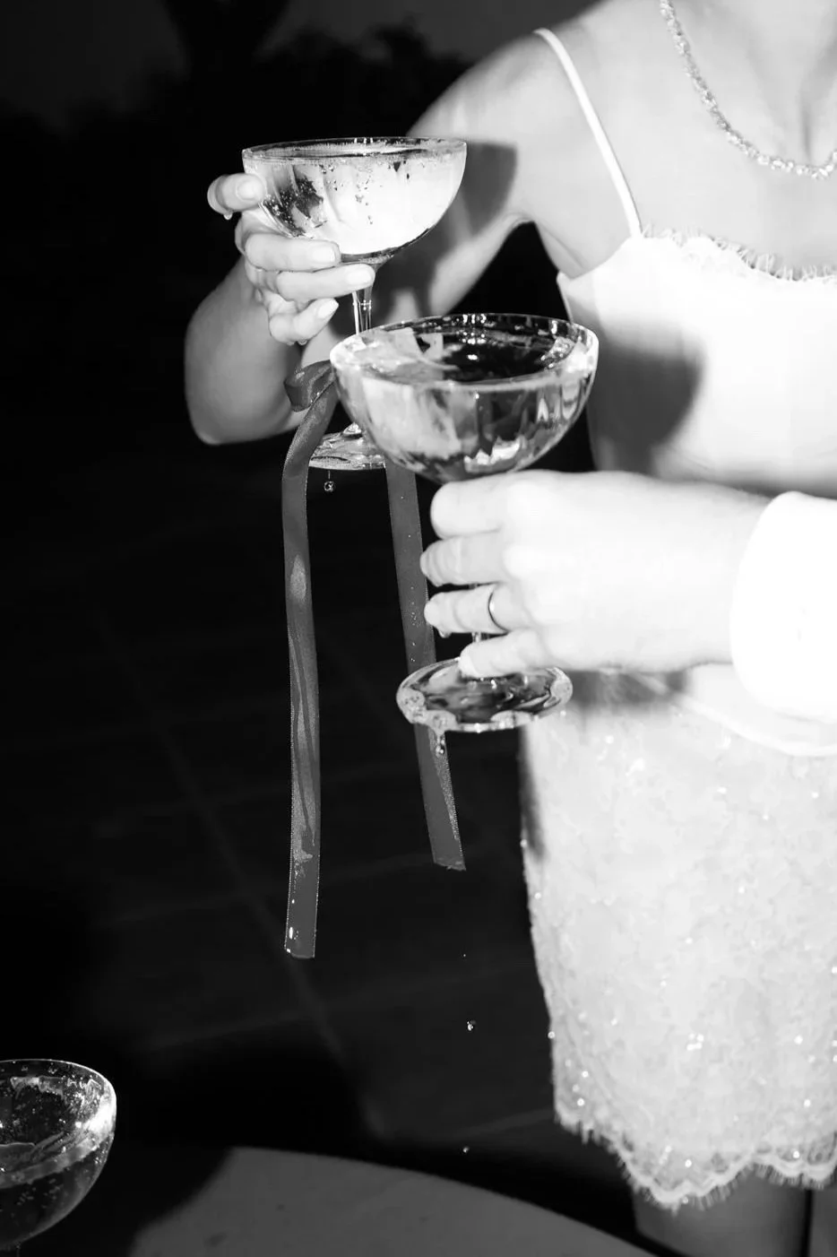 People holding cocktail glasses during a celebration or event.